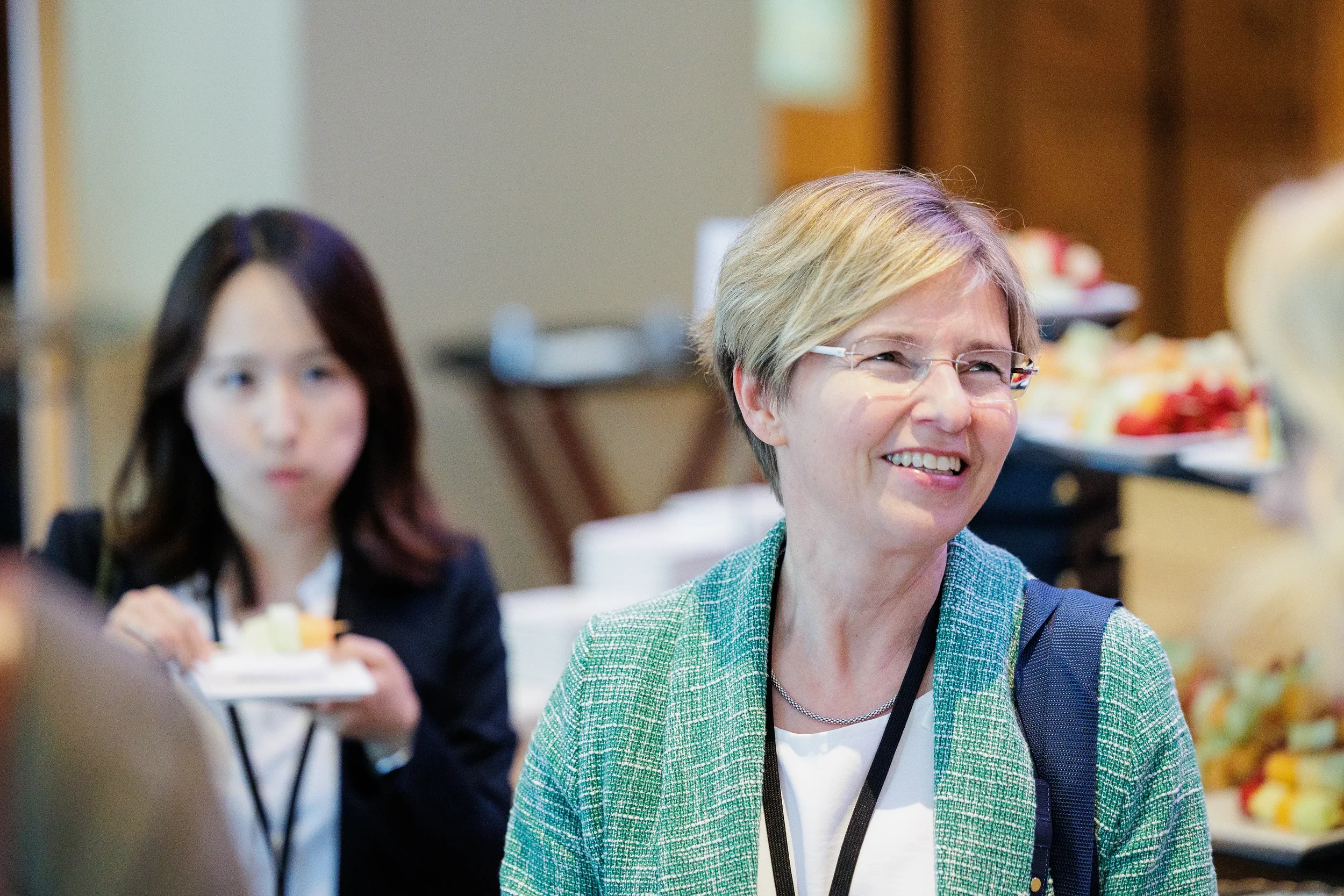 Attendee smiles while networking near dessert table during Chicago corporate event