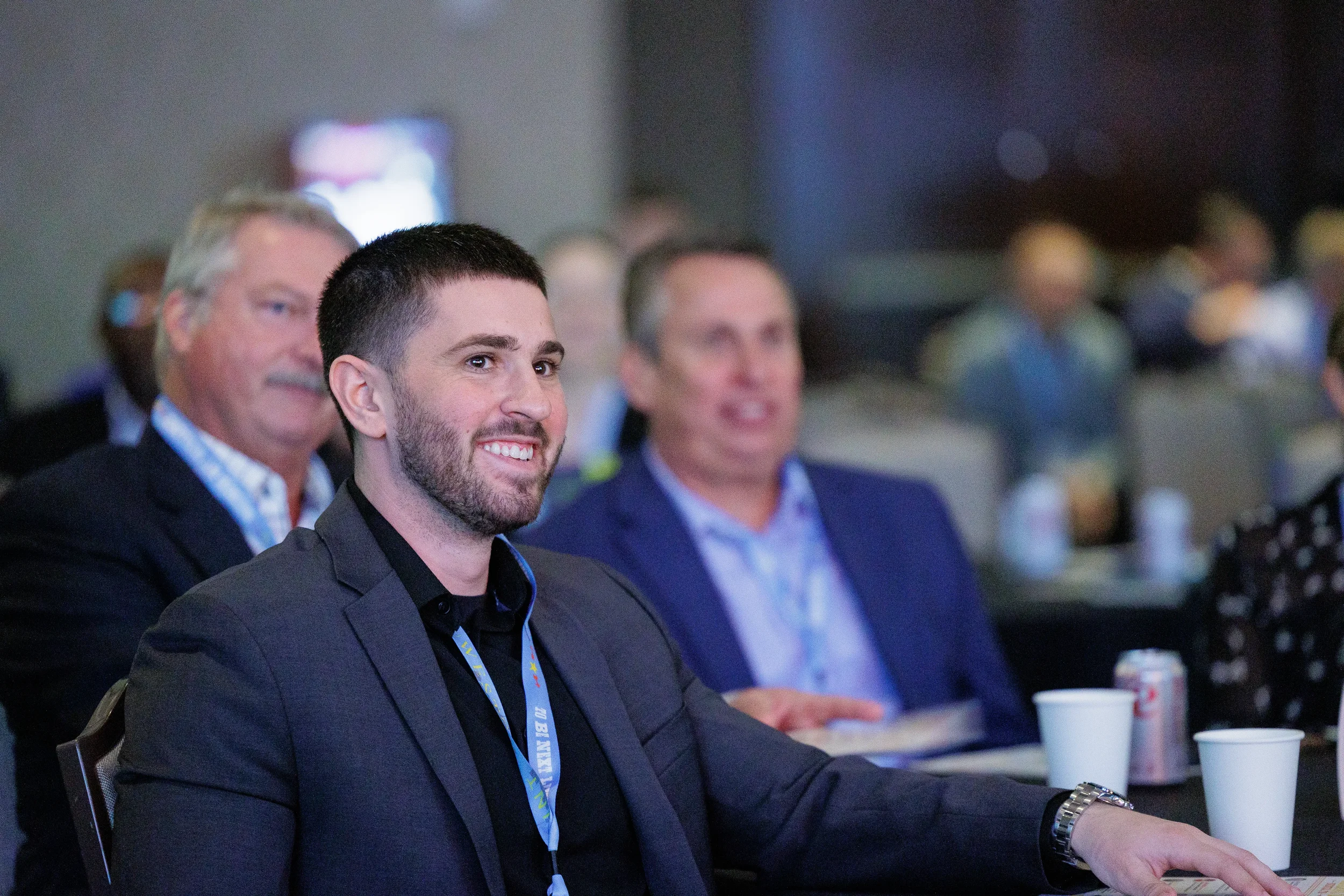 Attendee smiles while watching presentation during general session at Chicago conference