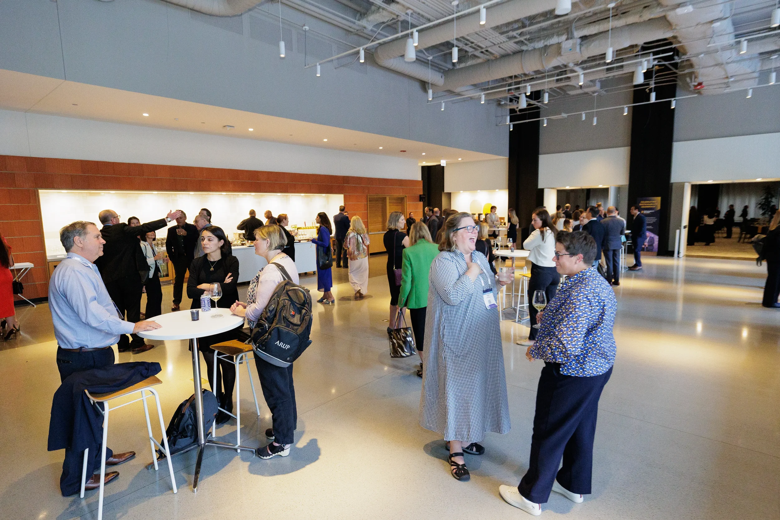 Attendees network at standing tables during Chicago corporate event reception