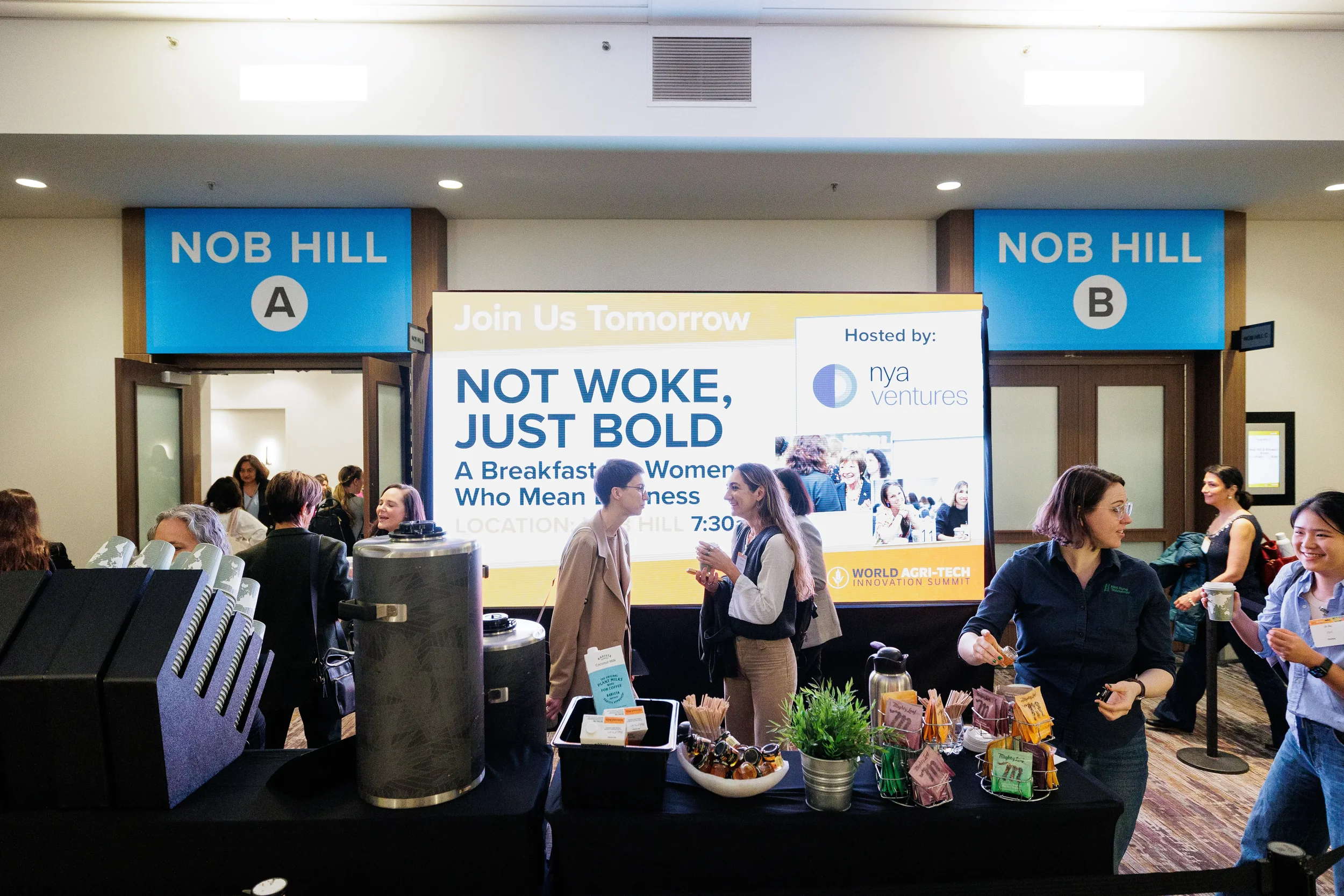 Attendees gather at coffee station near branded breakout room signage at Chicago corporate conference