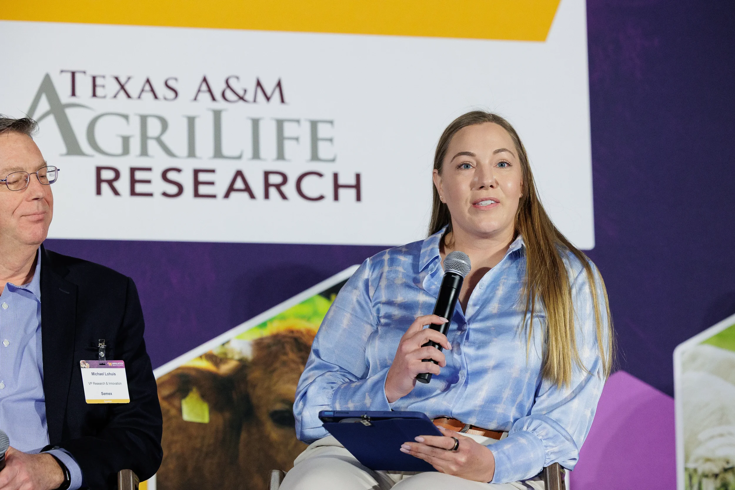 Panelist speaks into microphone during seated discussion at Chicago industry summit