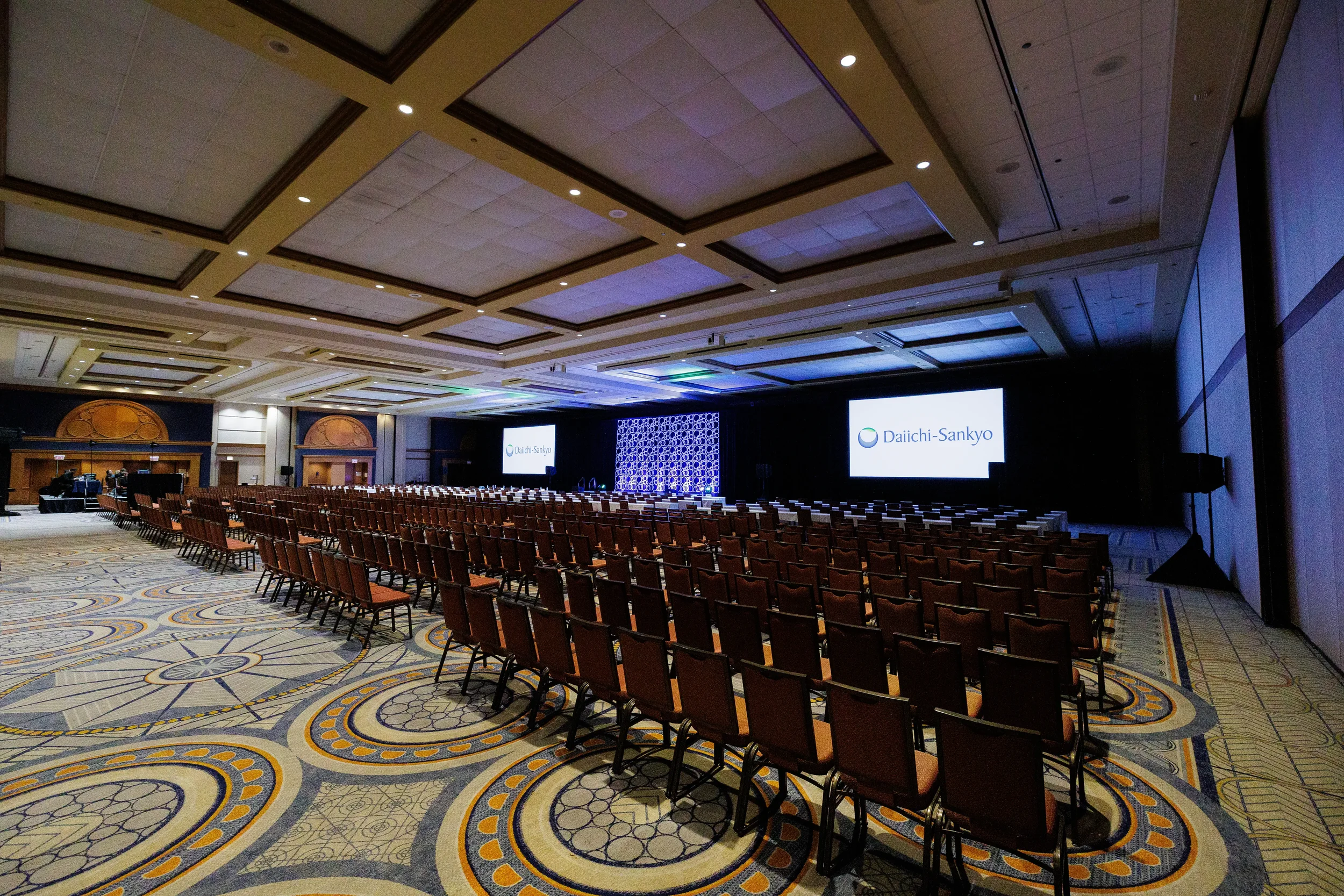 Ballroom set with theater-style seating and projection screens ahead of Chicago corporate meeting