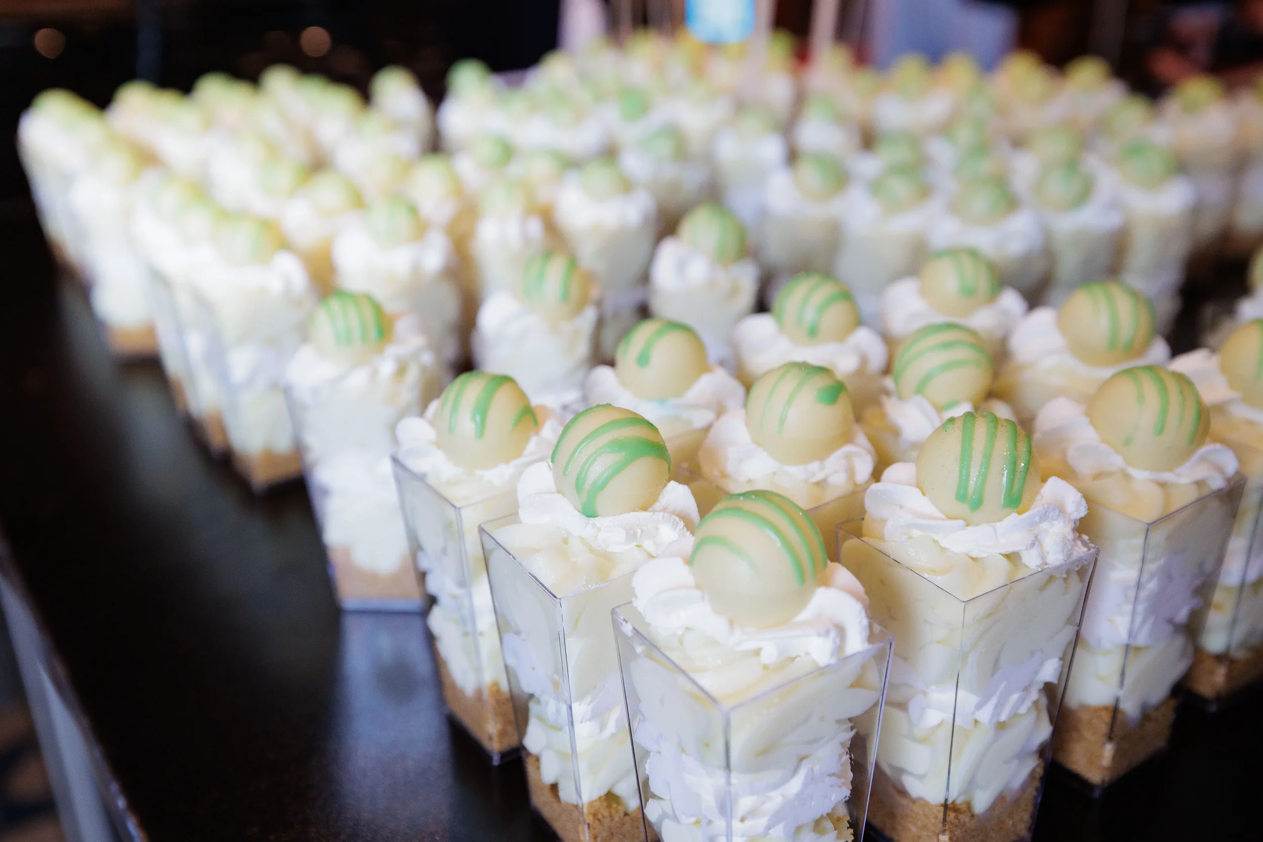 Rows of individual dessert cups with whipped cream and chocolate garnish at Chicago corporate event