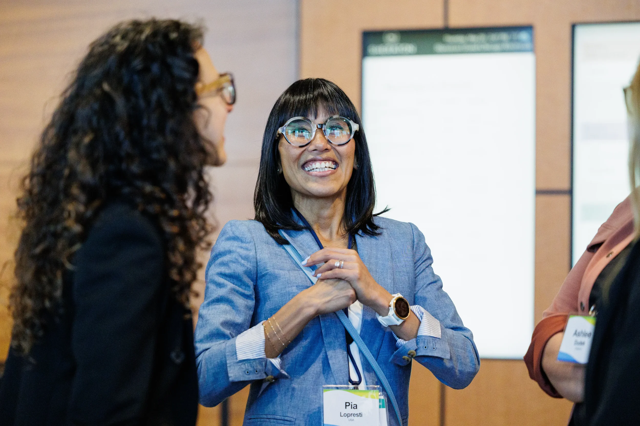 Attendee laughs during conversation with colleagues at Chicago industry conference