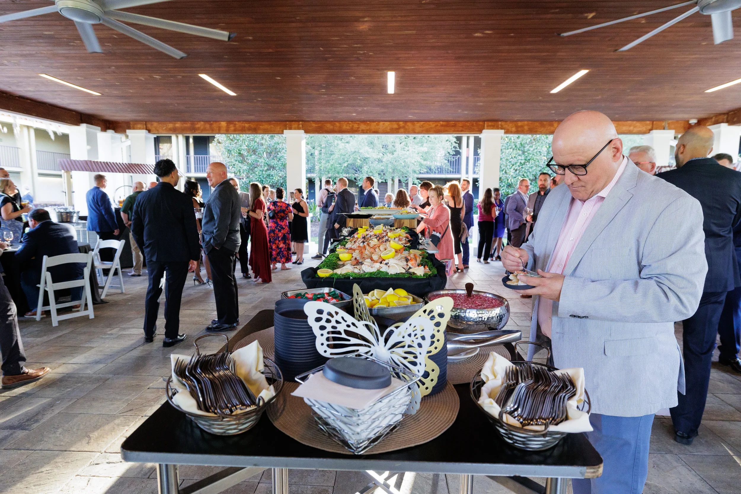 Attendee browses decorated outdoor catering table during Chicago corporate event networking reception