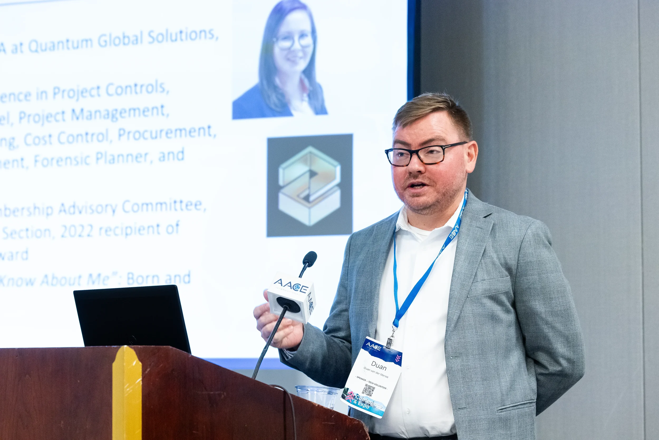 Presenter speaking at podium during Chicago conference breakout session with slides displayed
