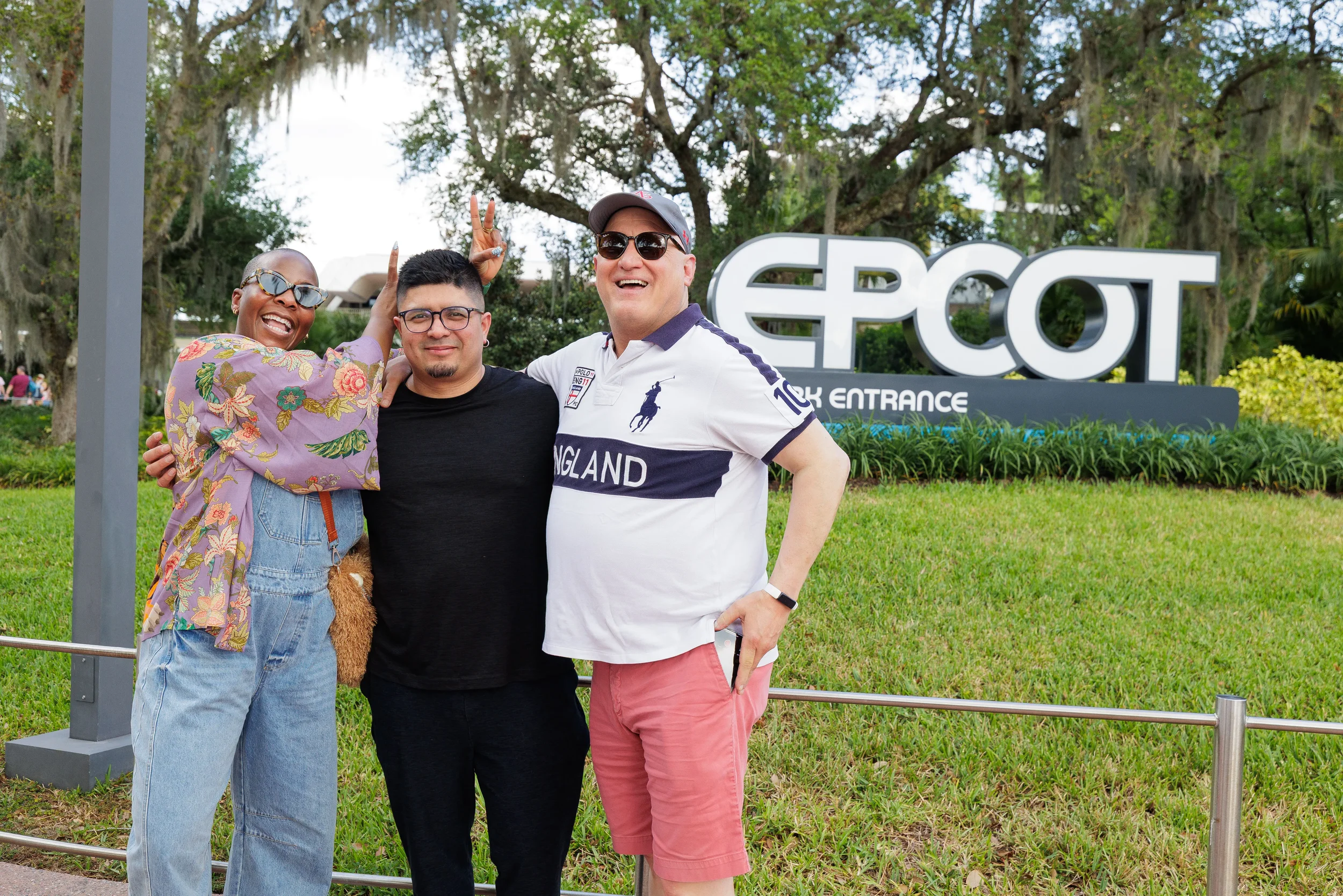 Three laughing conference attendees pose together during outdoor group excursion at Chicago corporate event