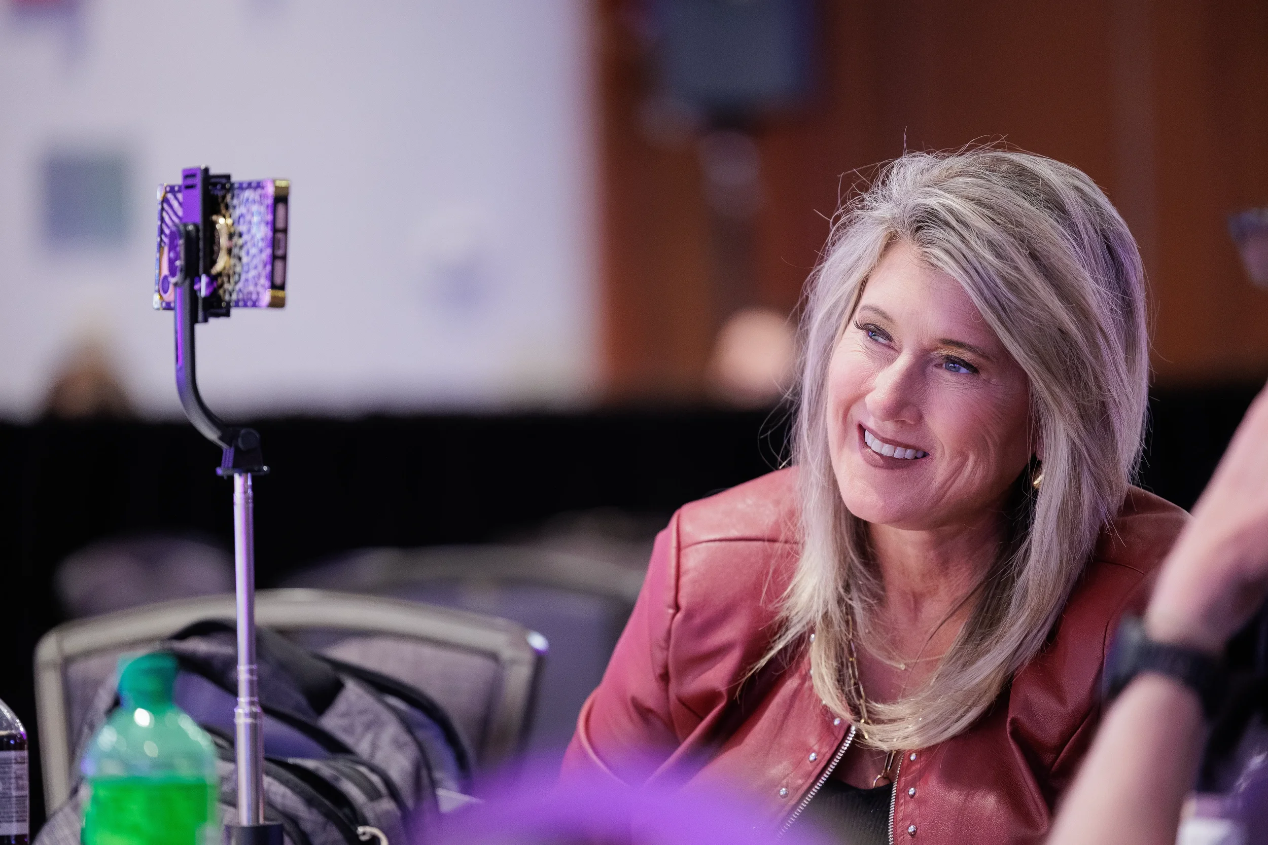 Attendee smiles during seated session at Orlando corporate conference