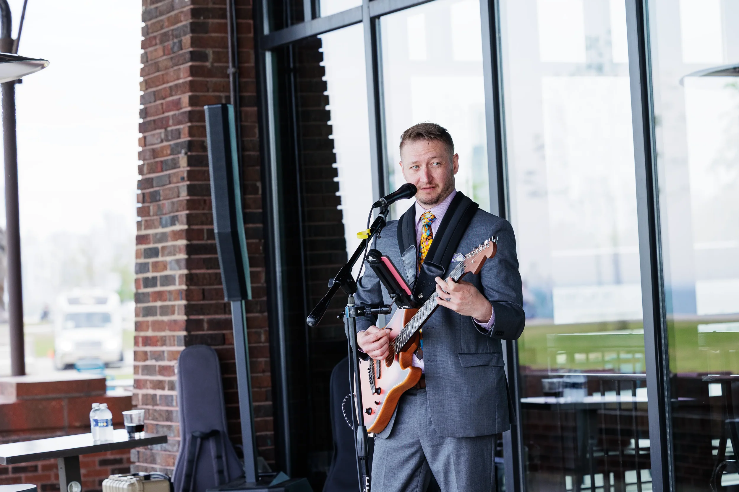 Musician performs on guitar during outdoor reception at Chicago networking event
