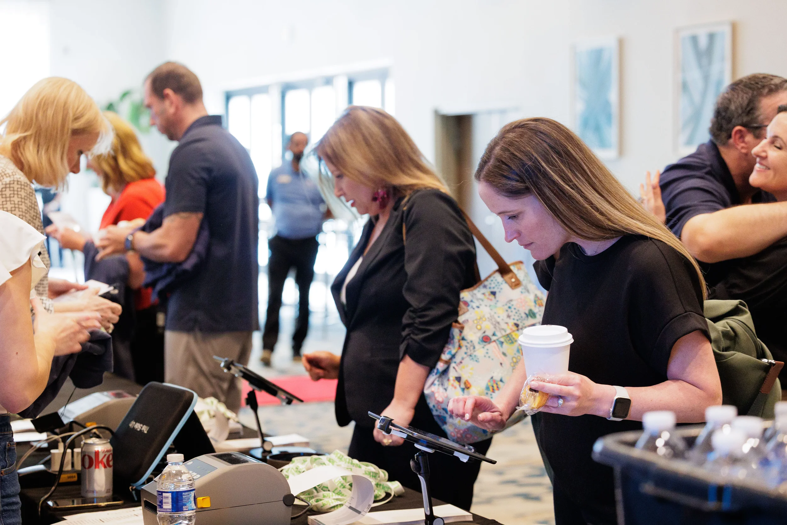 Attendees check in at registration table with coffee during Chicago corporate conference arrival