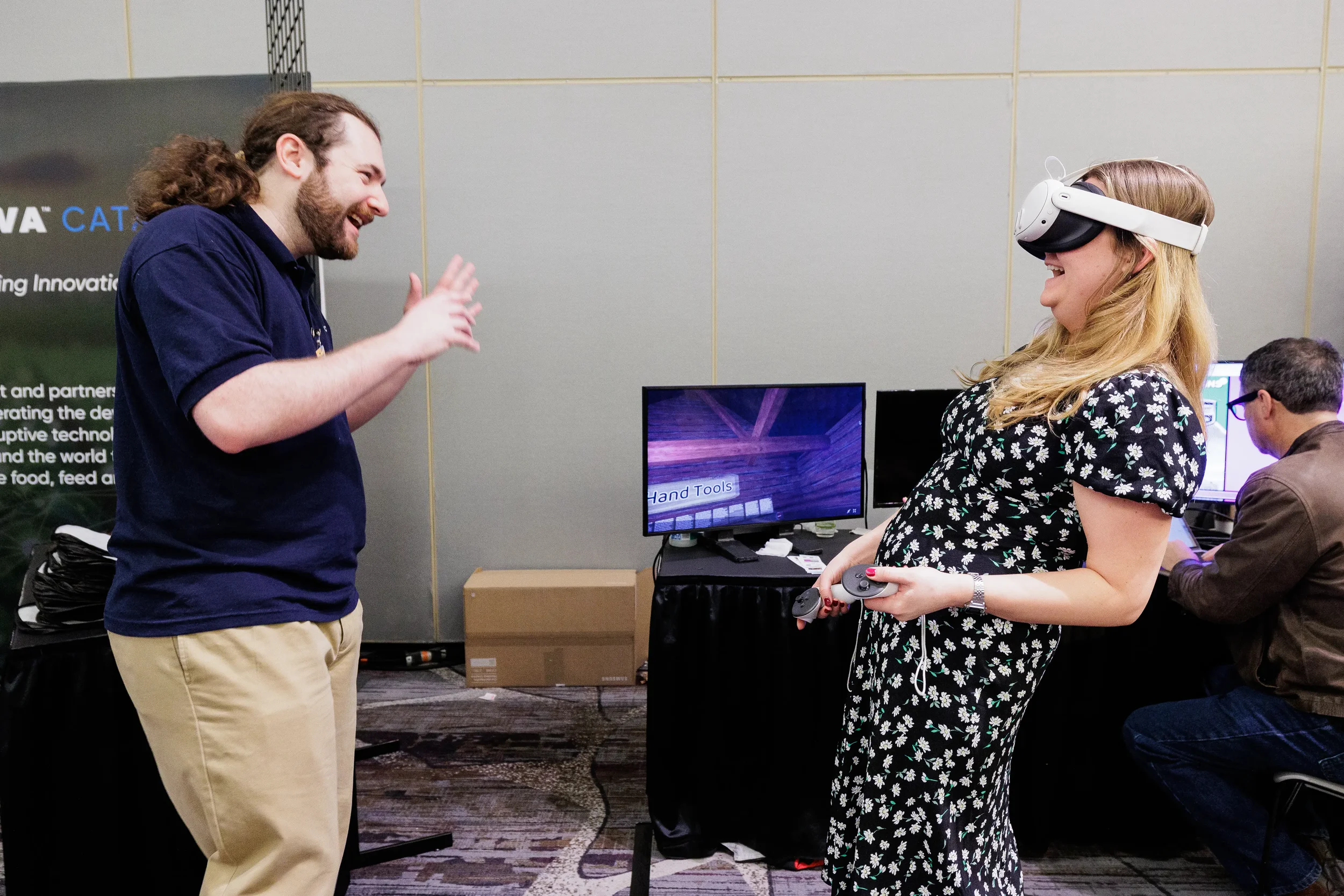 Attendee laughs trying virtual reality headset demo at Orlando industry conference booth