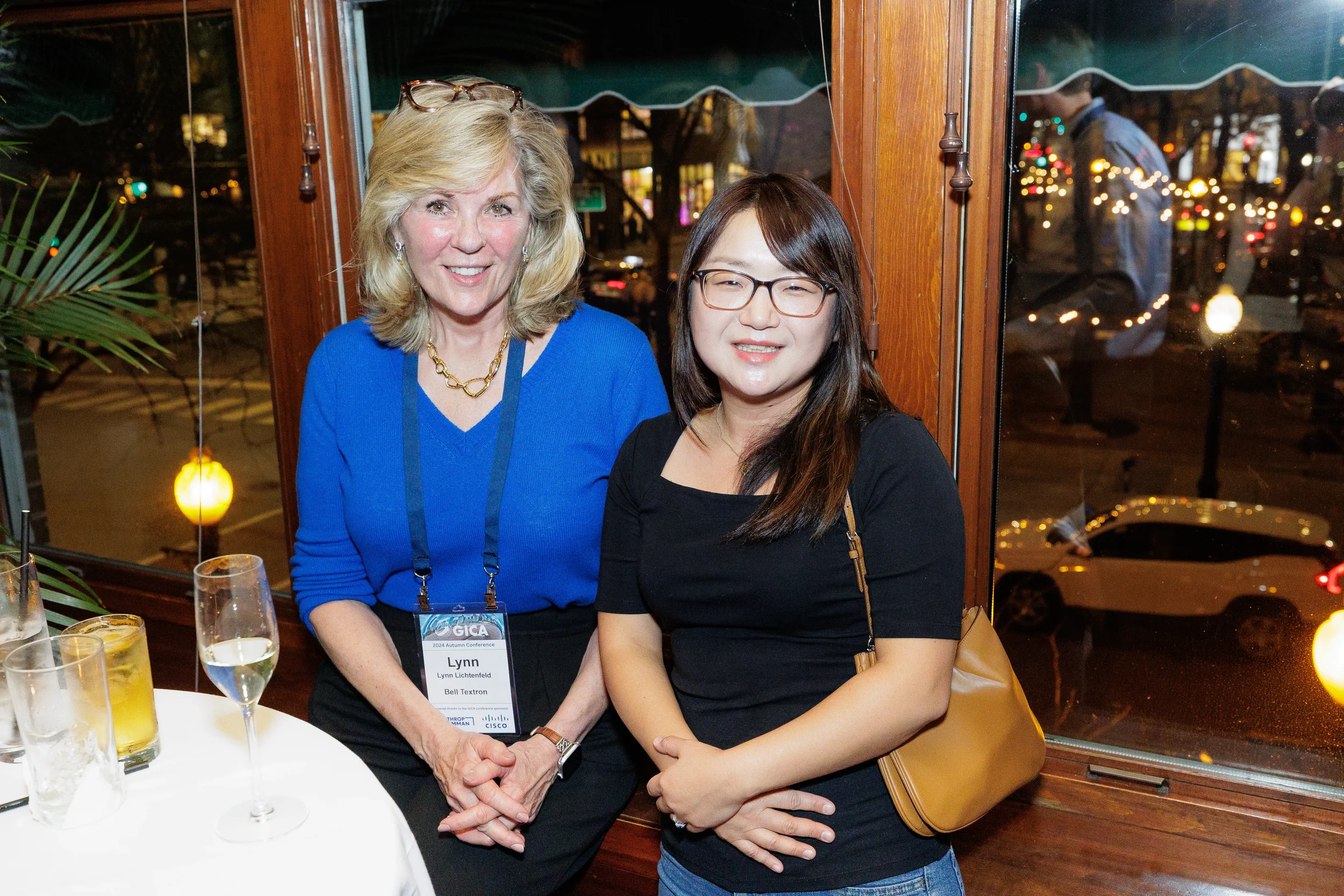 Two conference attendees pose for a photo during corporate dinner event in Orlando