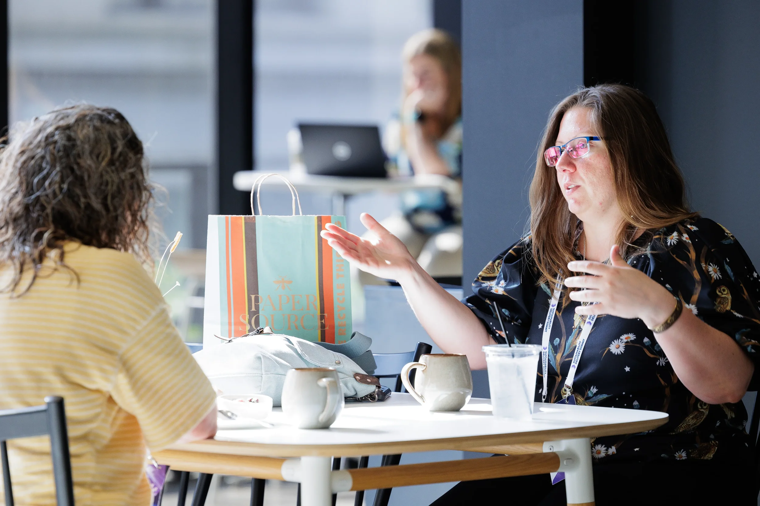 Attendees converse over coffee at table during Chicago industry conference networking break