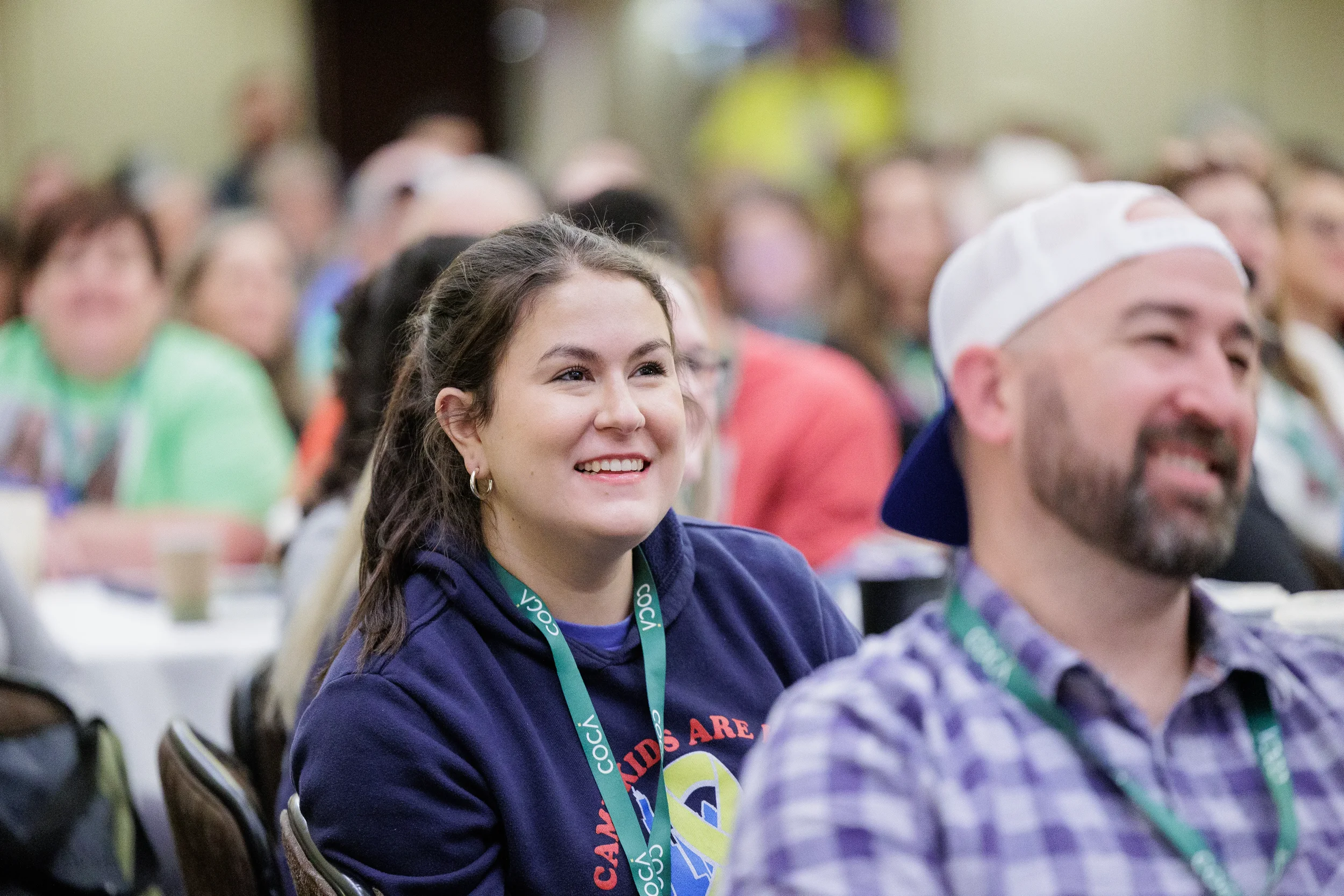 Attendees smile and laugh while watching presentation during session at Orlando conference