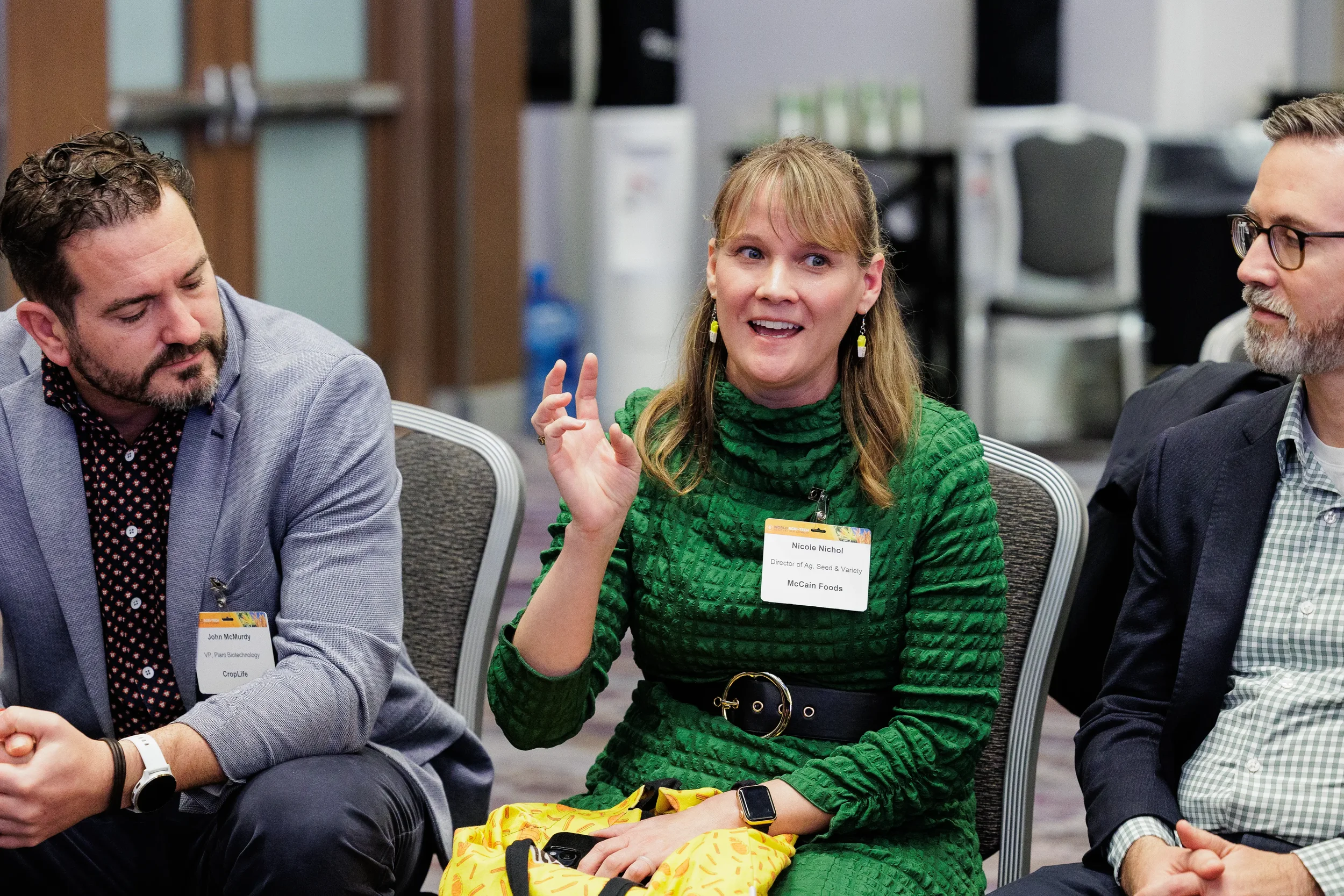 Panelist gestures while speaking during seated panel discussion at Chicago industry conference