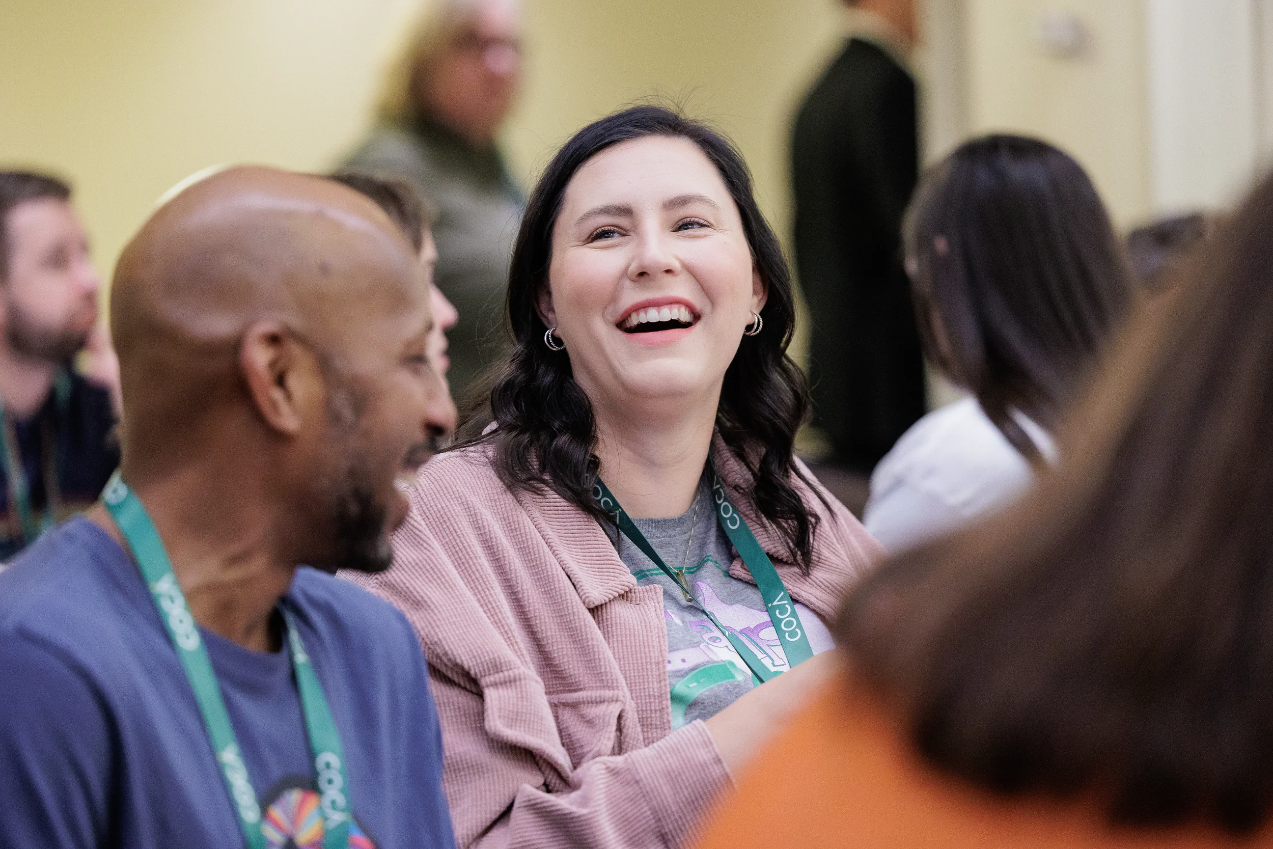 Attendee laughs while conversing with others at Orlando nonprofit conference event