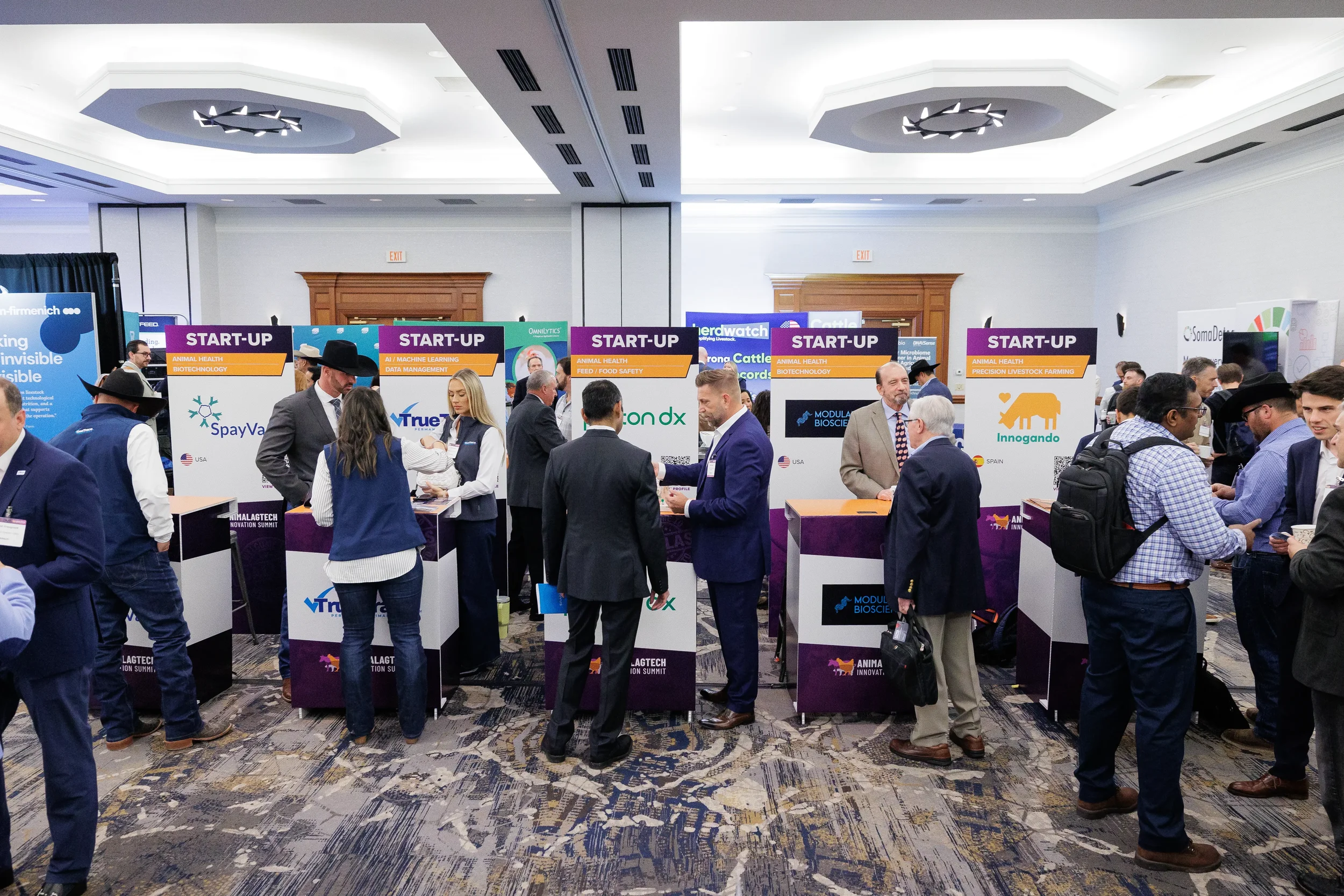 Attendees browse startup exhibitor booths on crowded expo floor at Chicago corporate conference