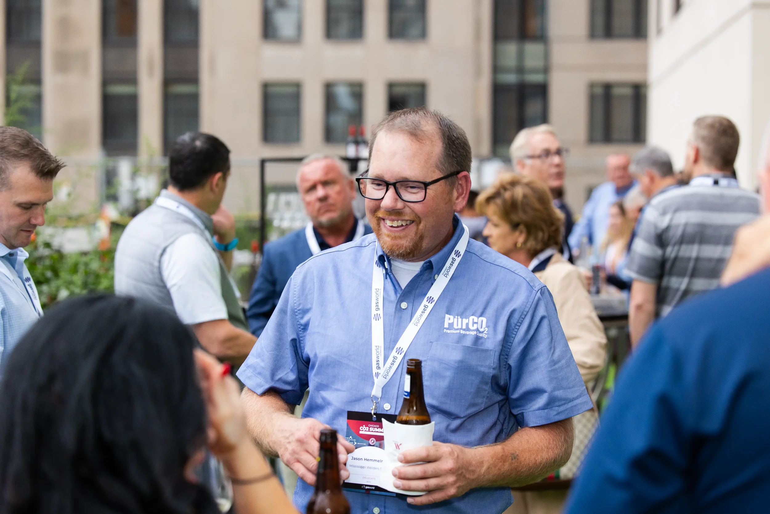 Conference attendee smiles while networking at outdoor reception during Chicago corporate event