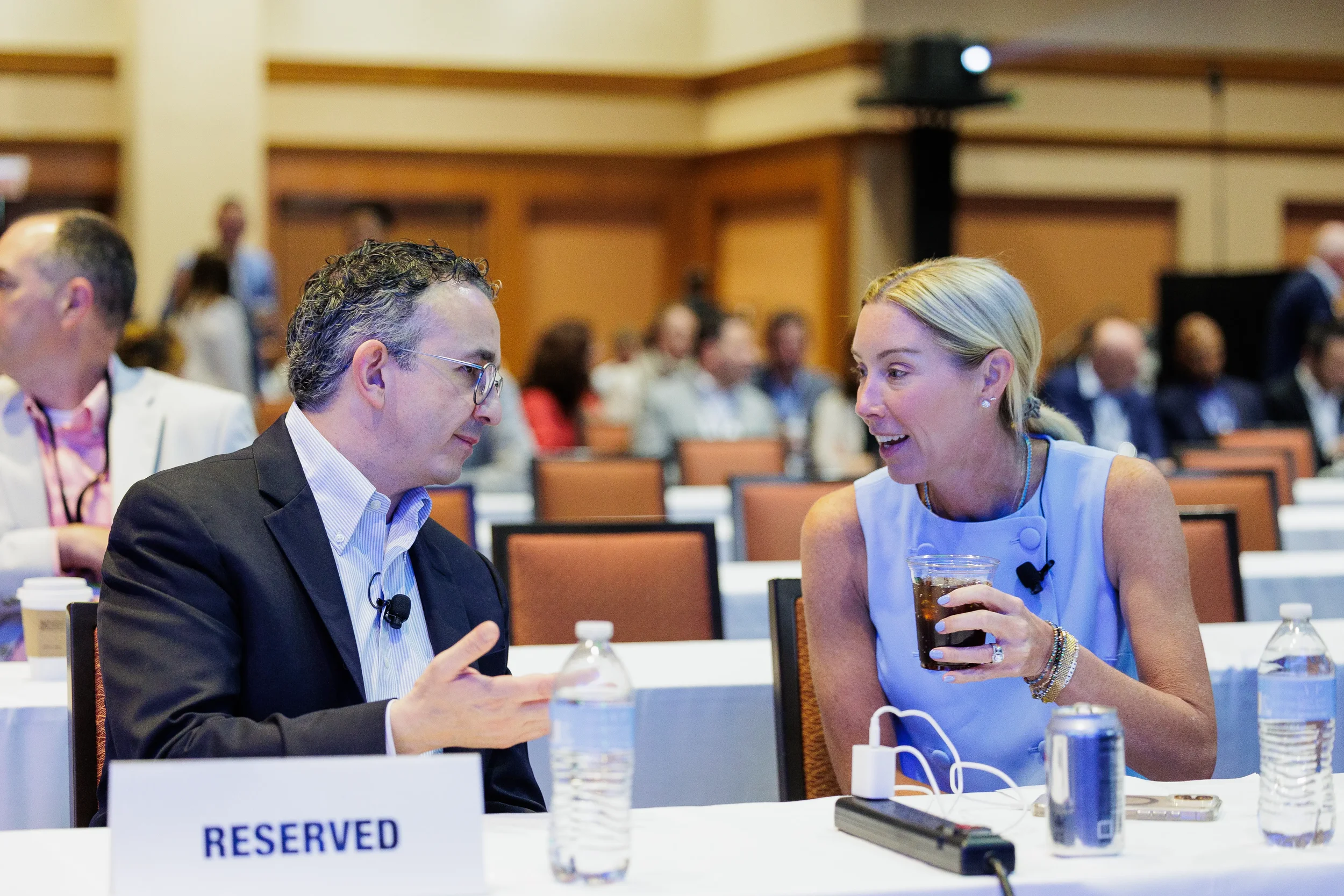 Two attendees engage in conversation at reserved table during Chicago industry conference