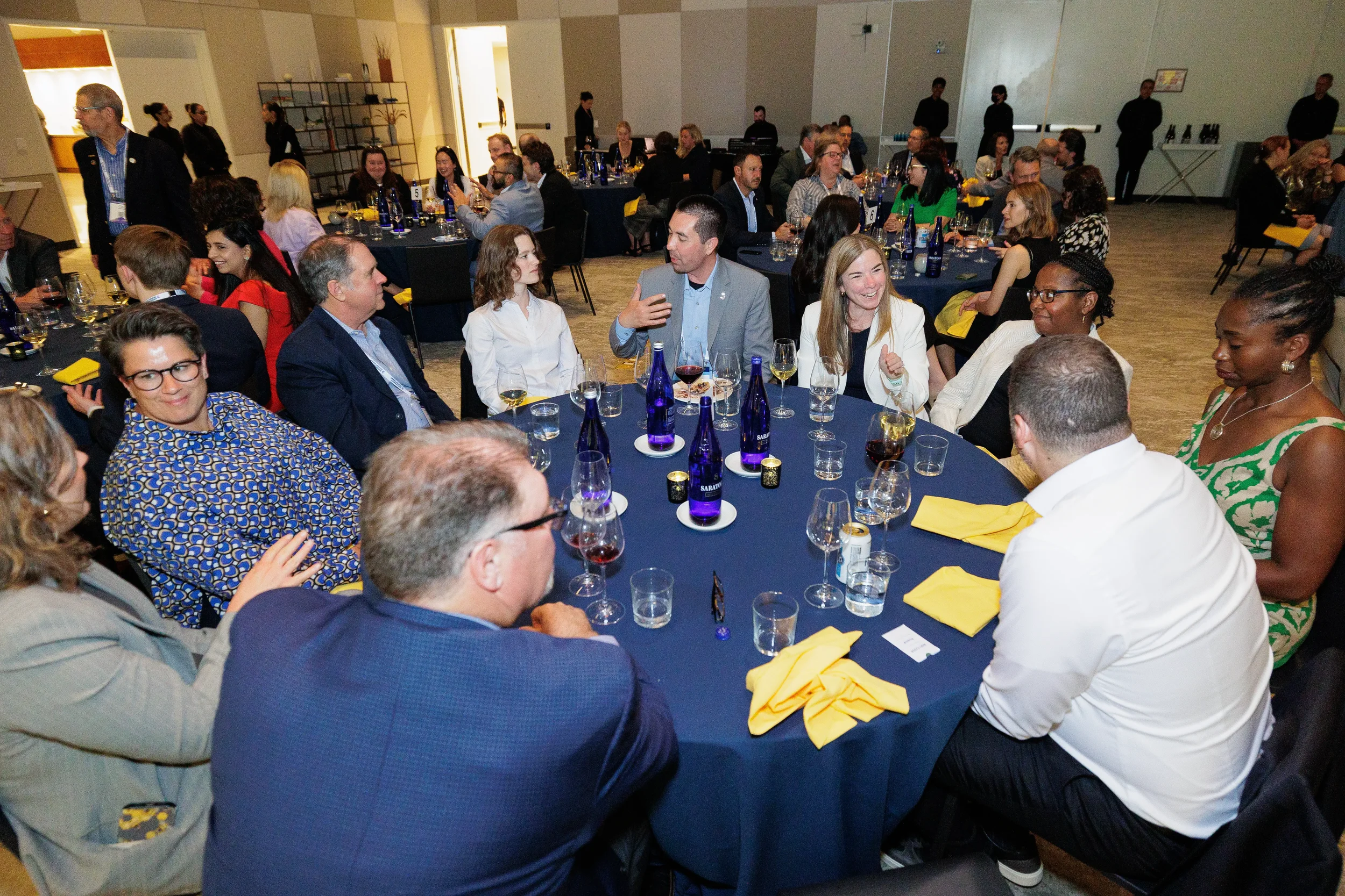 Attendees converse at seated dinner tables during Orlando corporate conference banquet