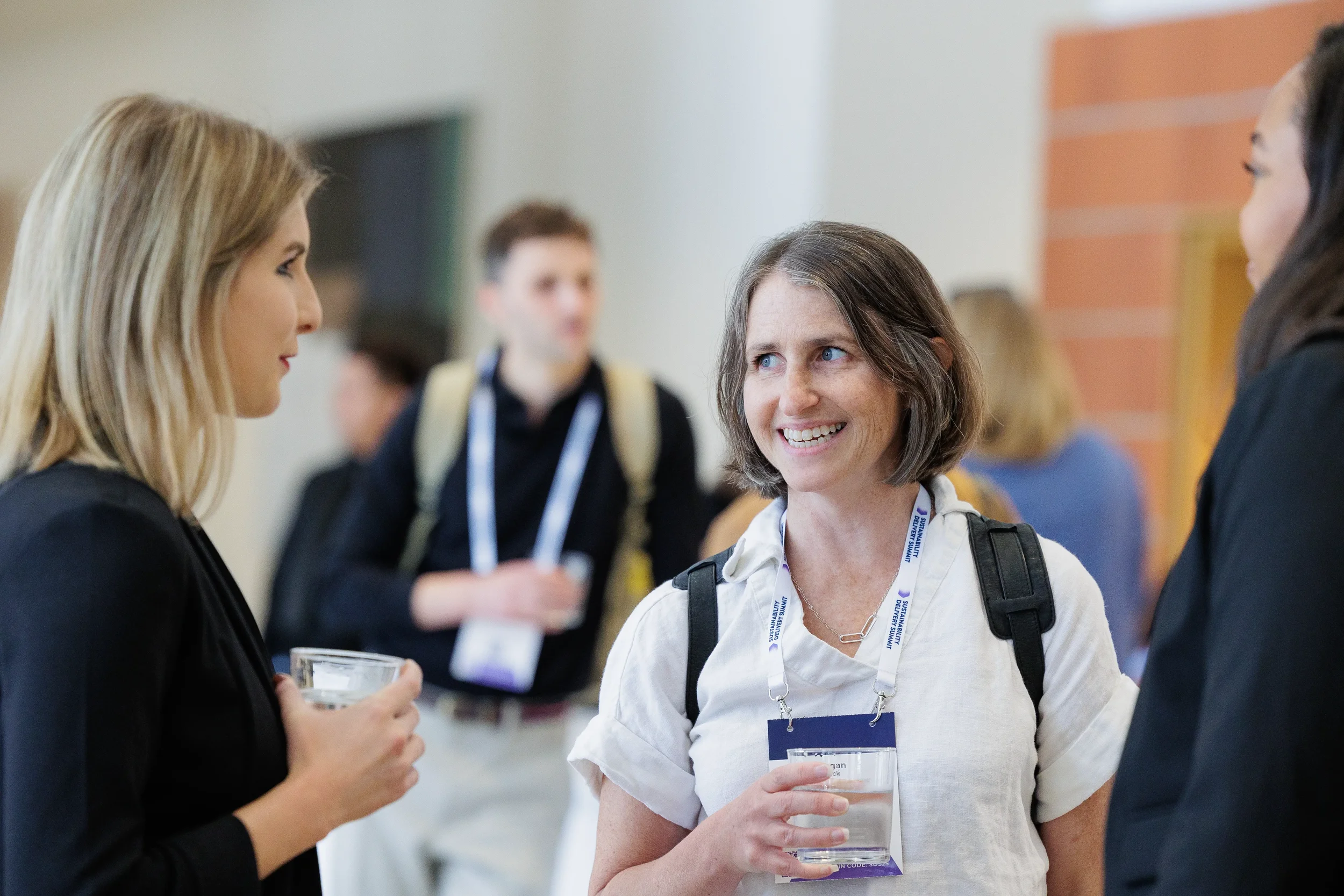 Attendees converse during networking break at Orlando corporate conference event