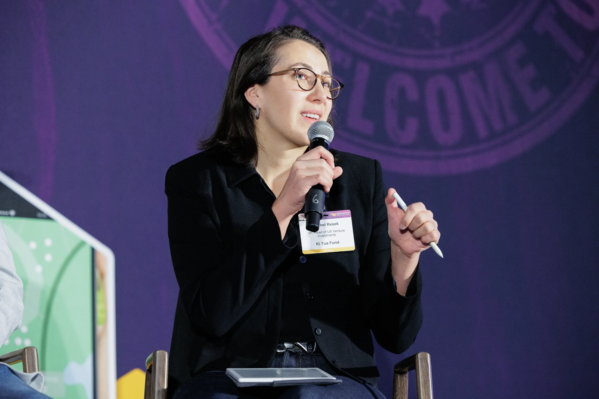 Panelist speaks into microphone during seated discussion at Chicago corporate summit