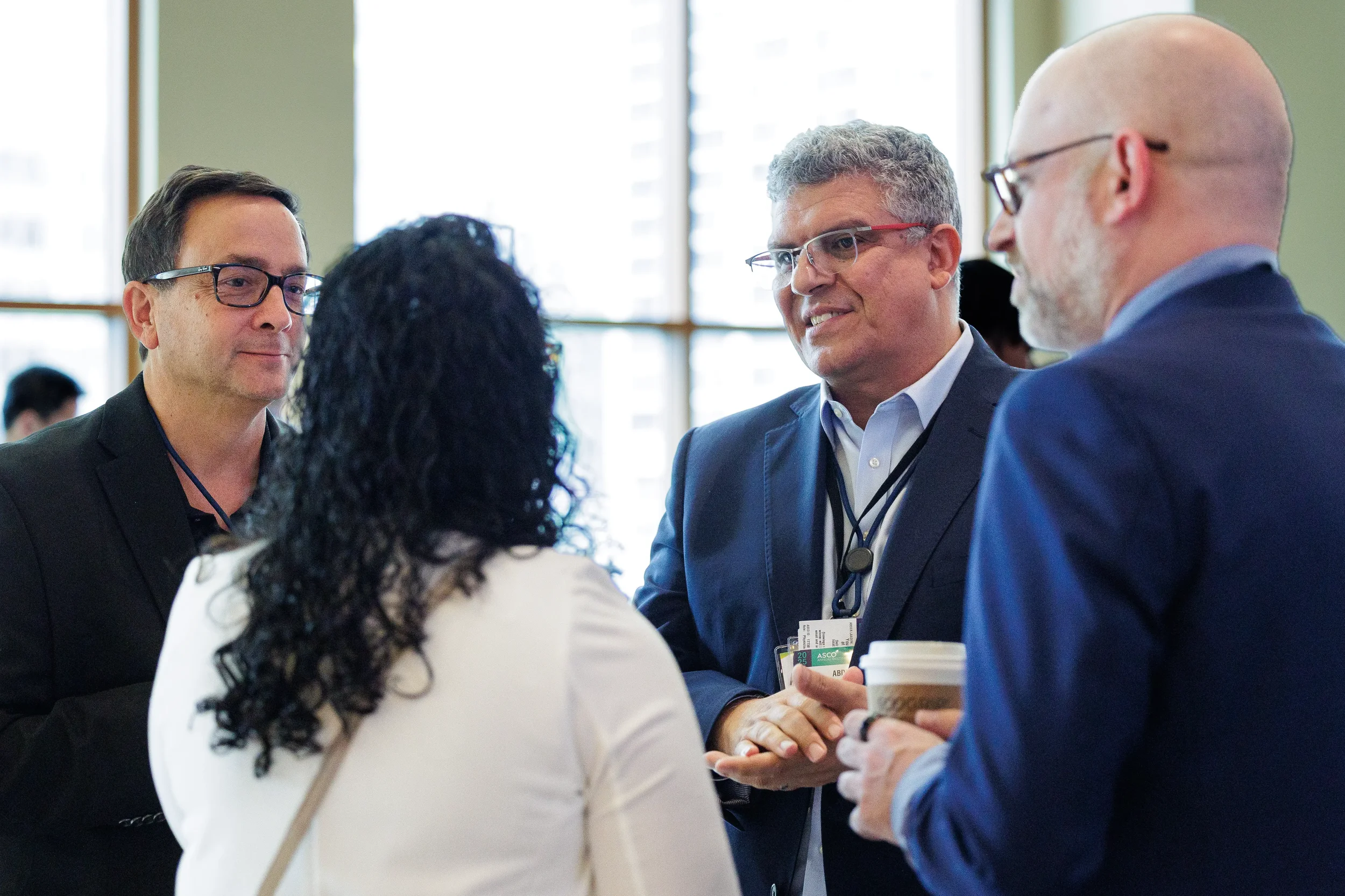 Attendees engage in group conversation during break at Chicago corporate conference