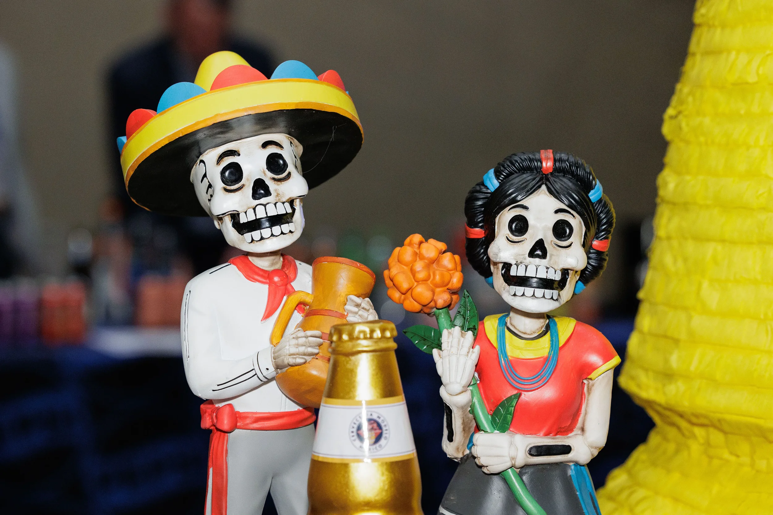 Colorful Day of the Dead figurines displayed as event decor at Chicago corporate conference