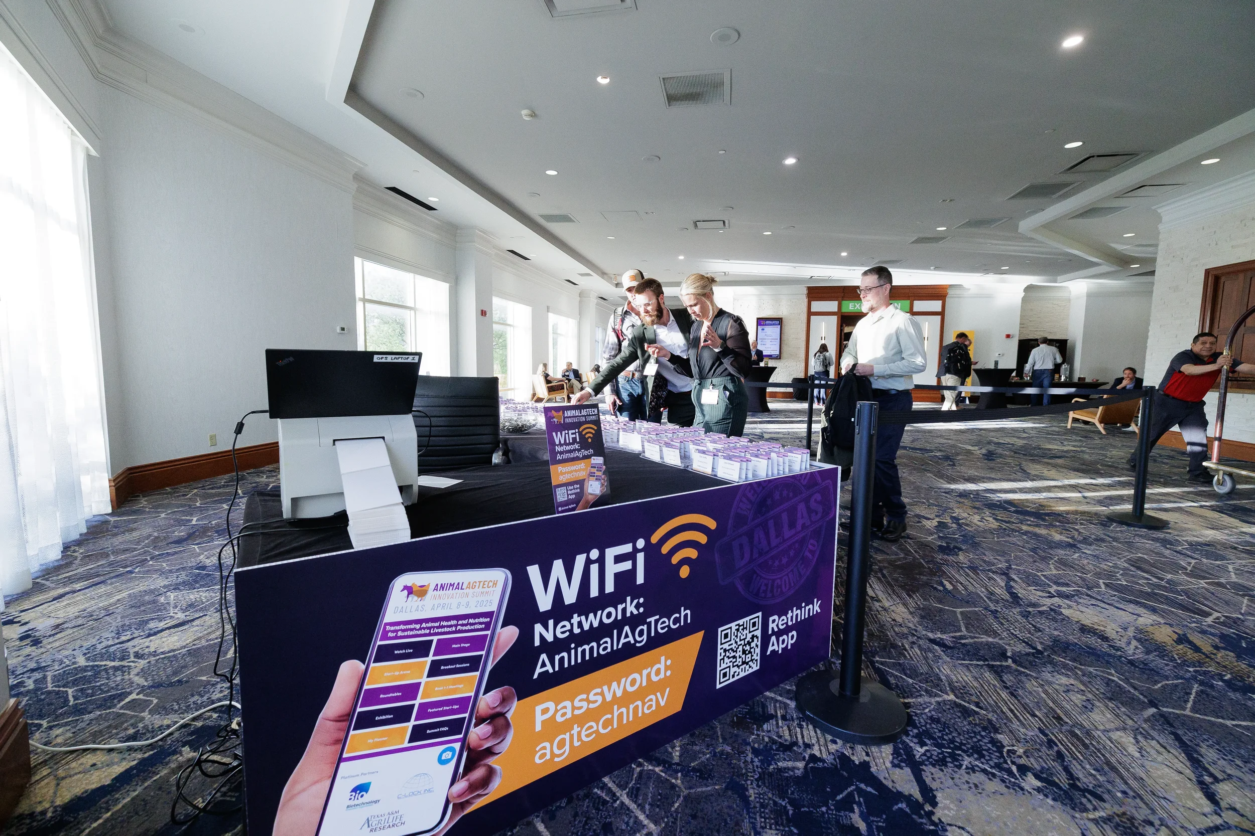 Attendees check in at registration table in lobby at Orlando corporate conference