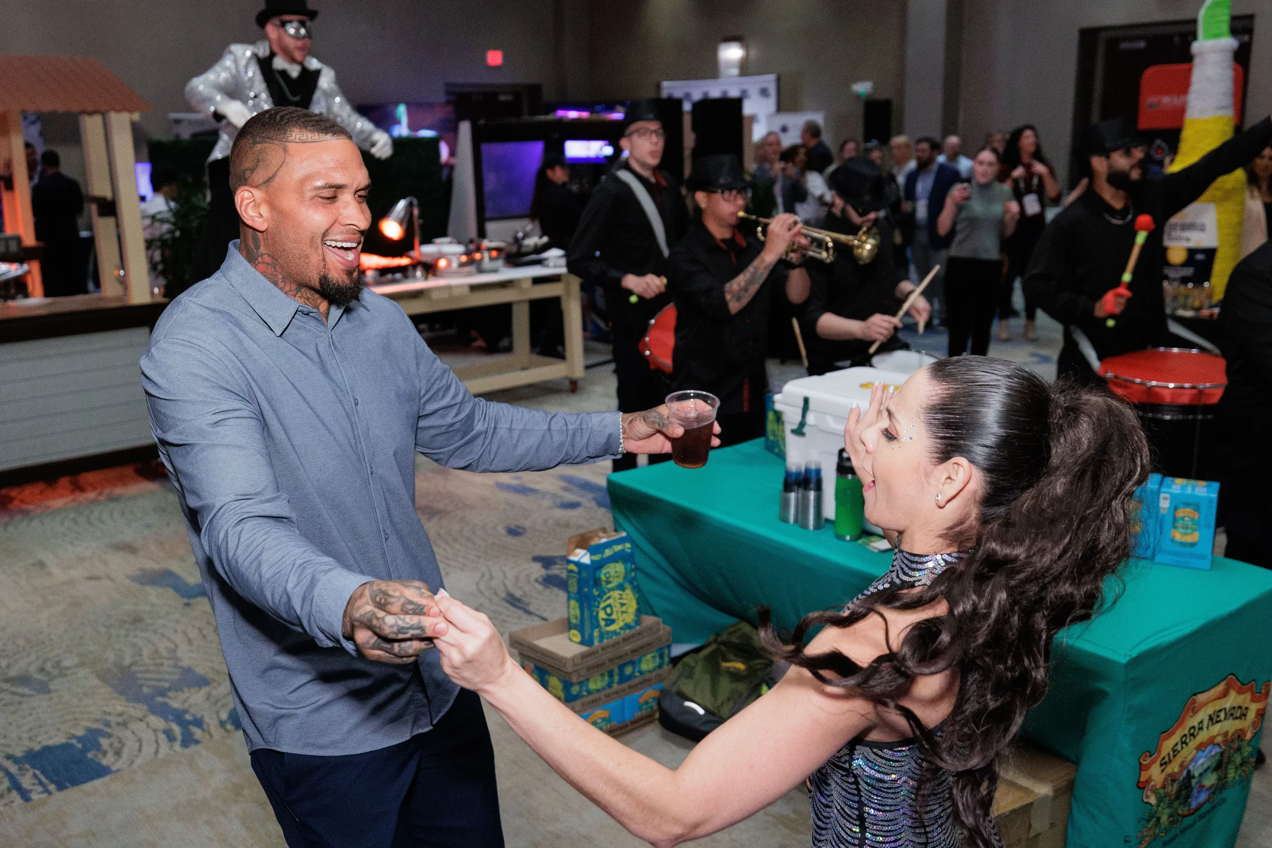 Attendee dances with sequin-dressed performer near live band at Orlando corporate conference expo reception