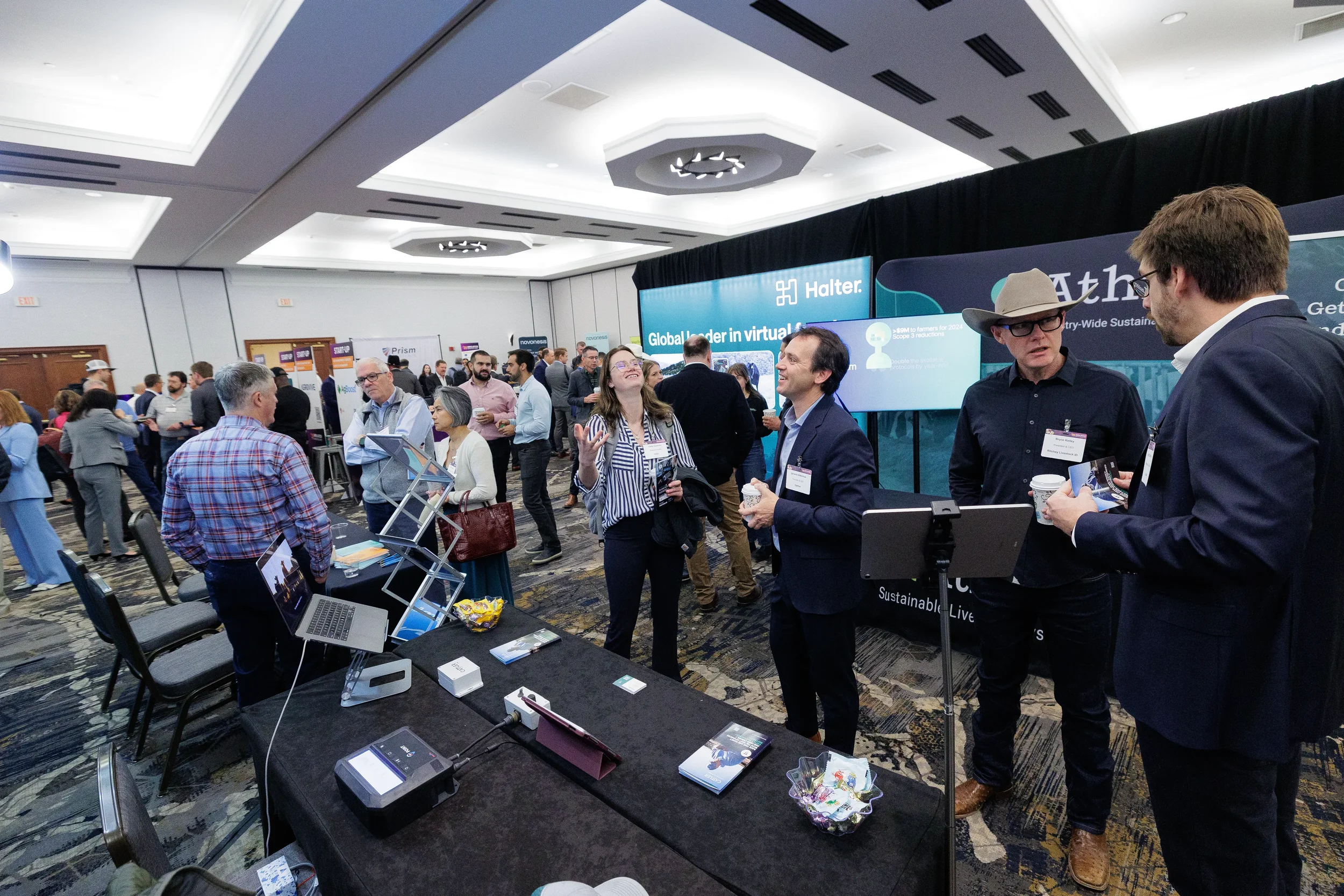Attendees converse at exhibitor booth on expo floor during Chicago corporate conference