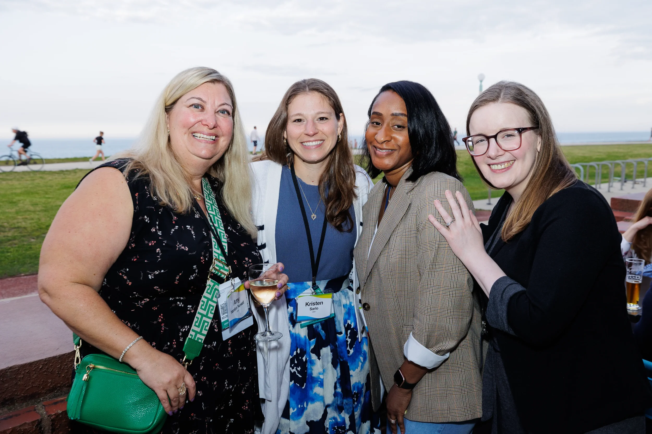 Four attendees pose together at lakefront reception during Orlando networking event