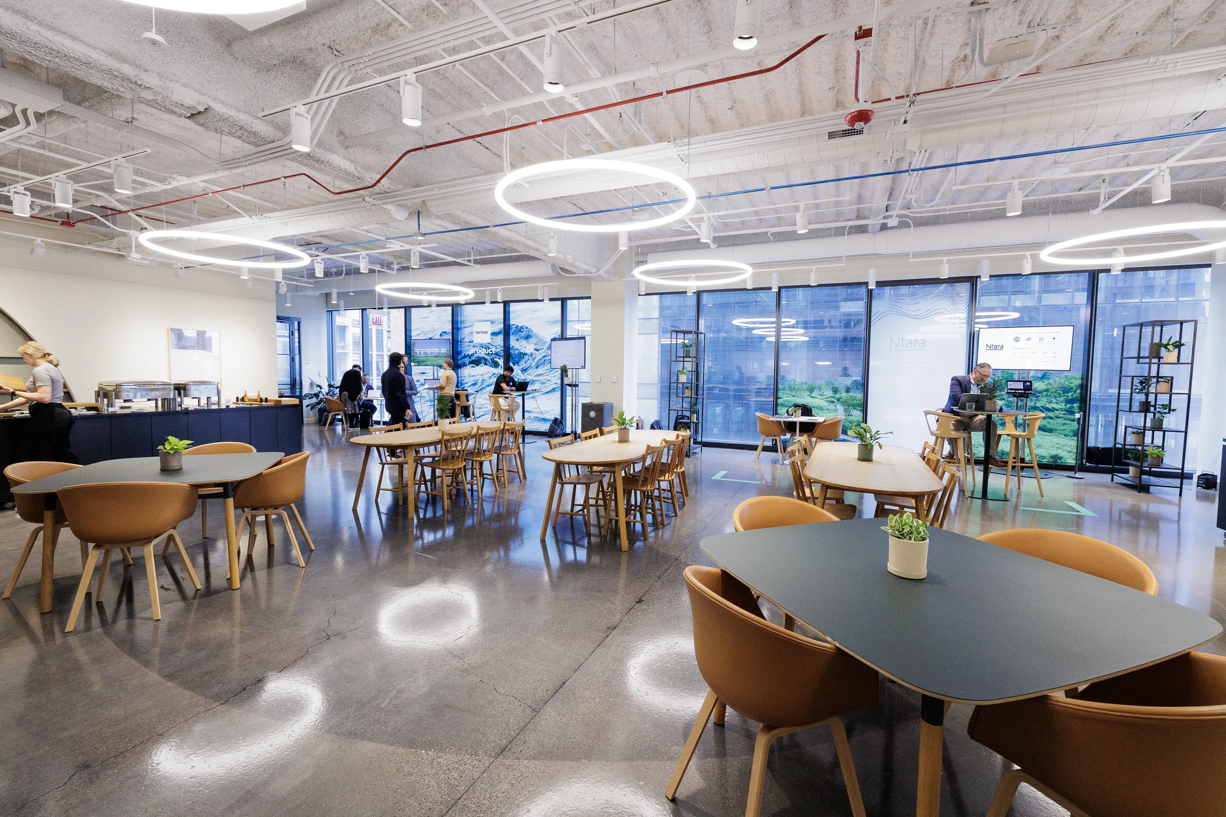 Modern networking lounge with tables, ring lights and attendees in background at Orlando corporate event