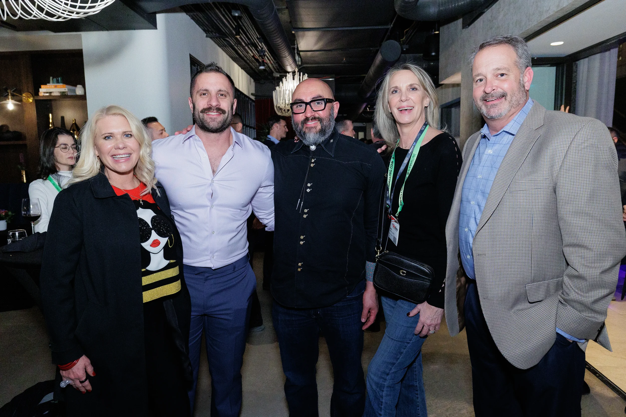 Five attendees smile together during networking reception at Chicago corporate event