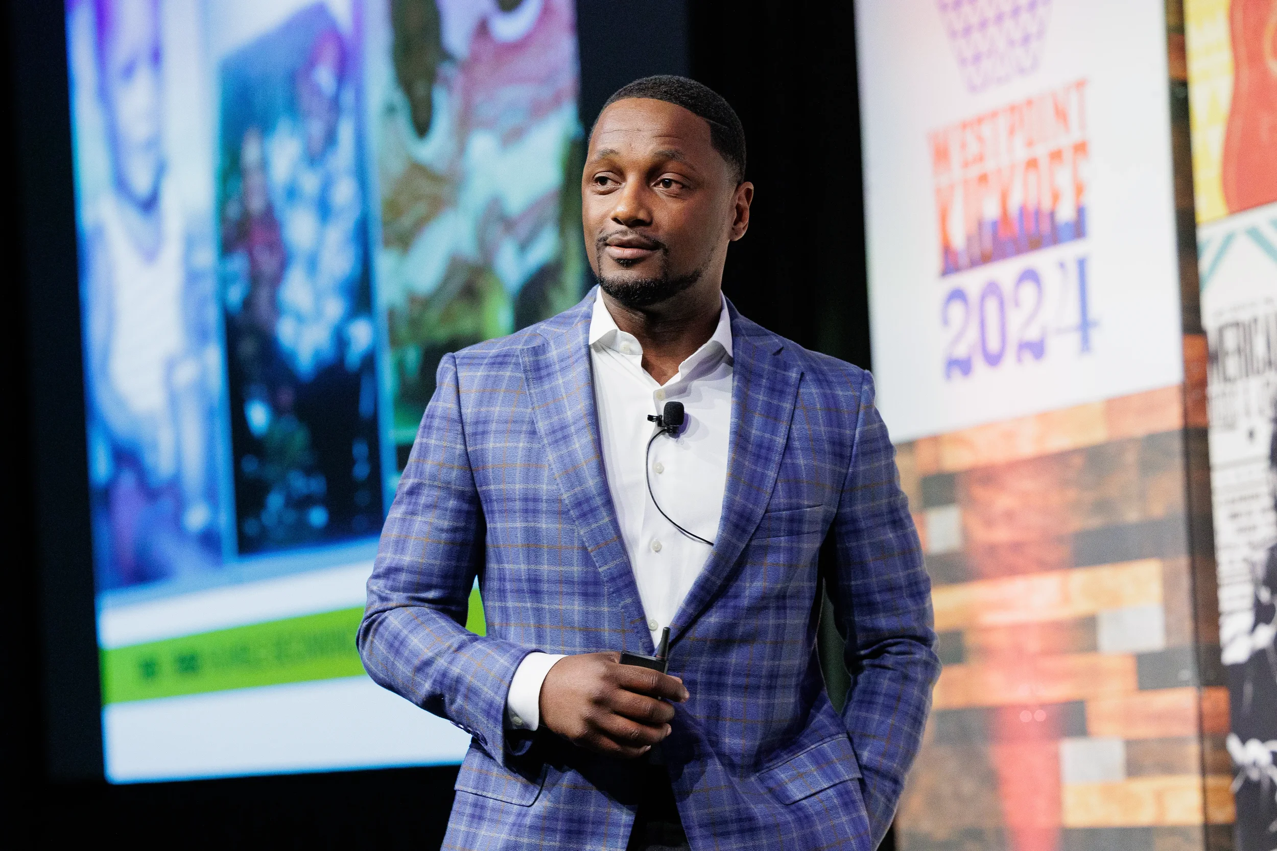 Speaker presents to audience in front of screens at Orlando corporate conference event