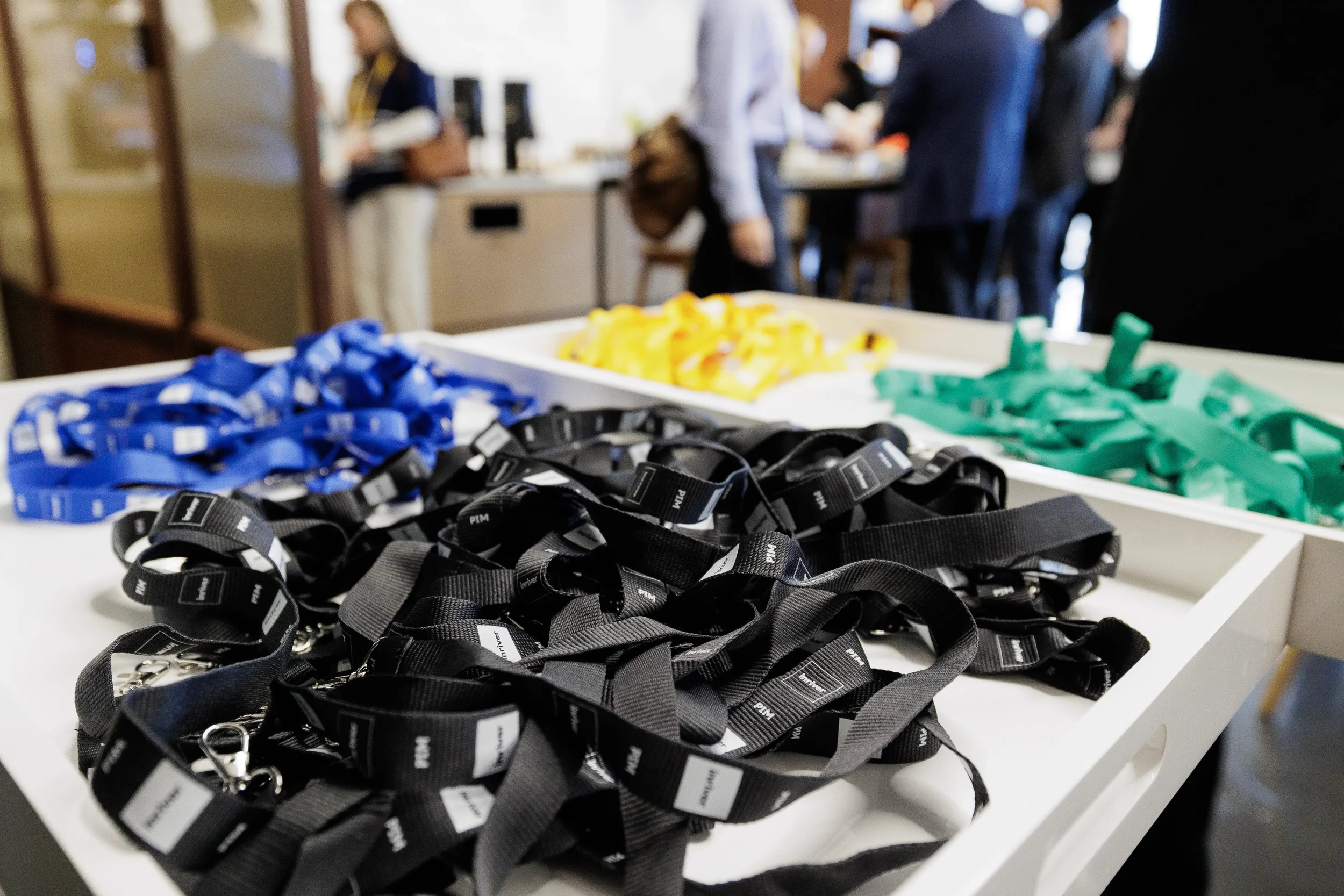 Colorful conference lanyards in white trays at registration table at Orlando corporate event