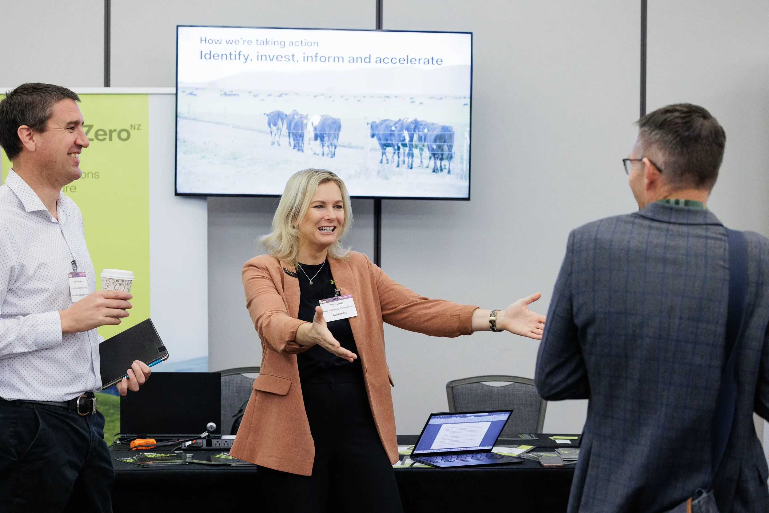 Attendee reaches to shake hands at expo booth during Orlando industry trade show