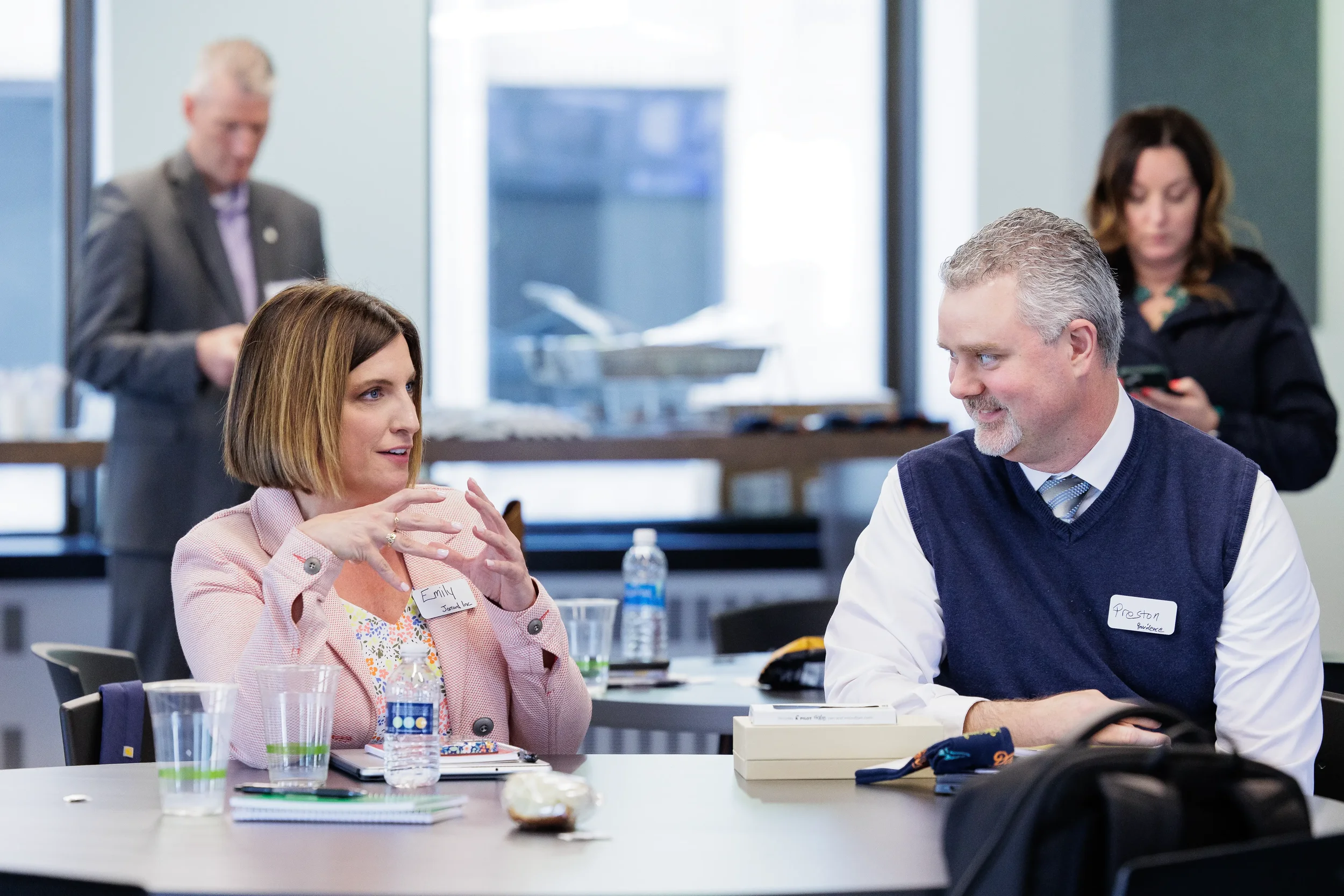 Female and male attendee converse at a table with laptops during a session at Chicago corporate event