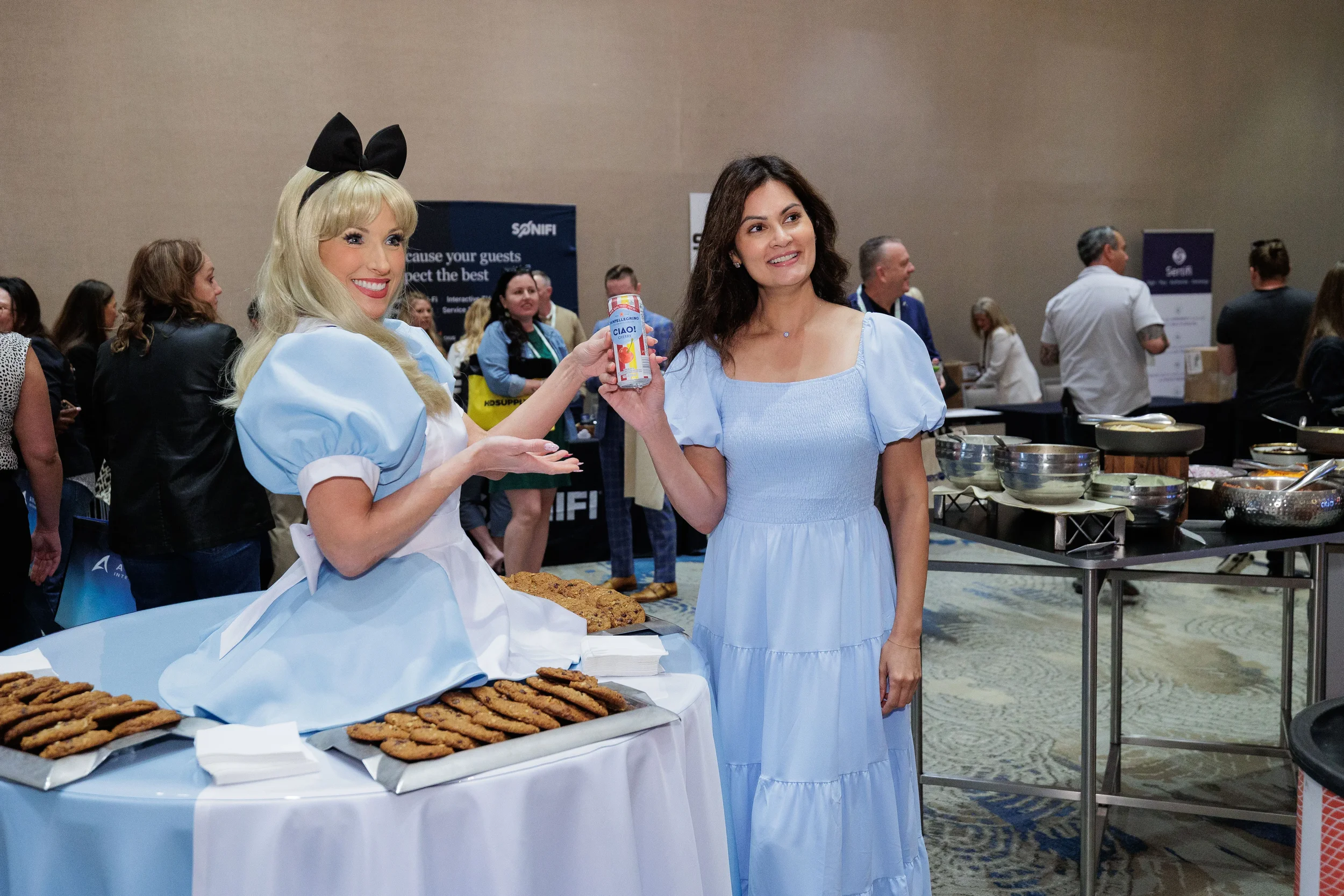 Costumed character and attendee pose together at exhibitor booth on Orlando corporate conference expo floor