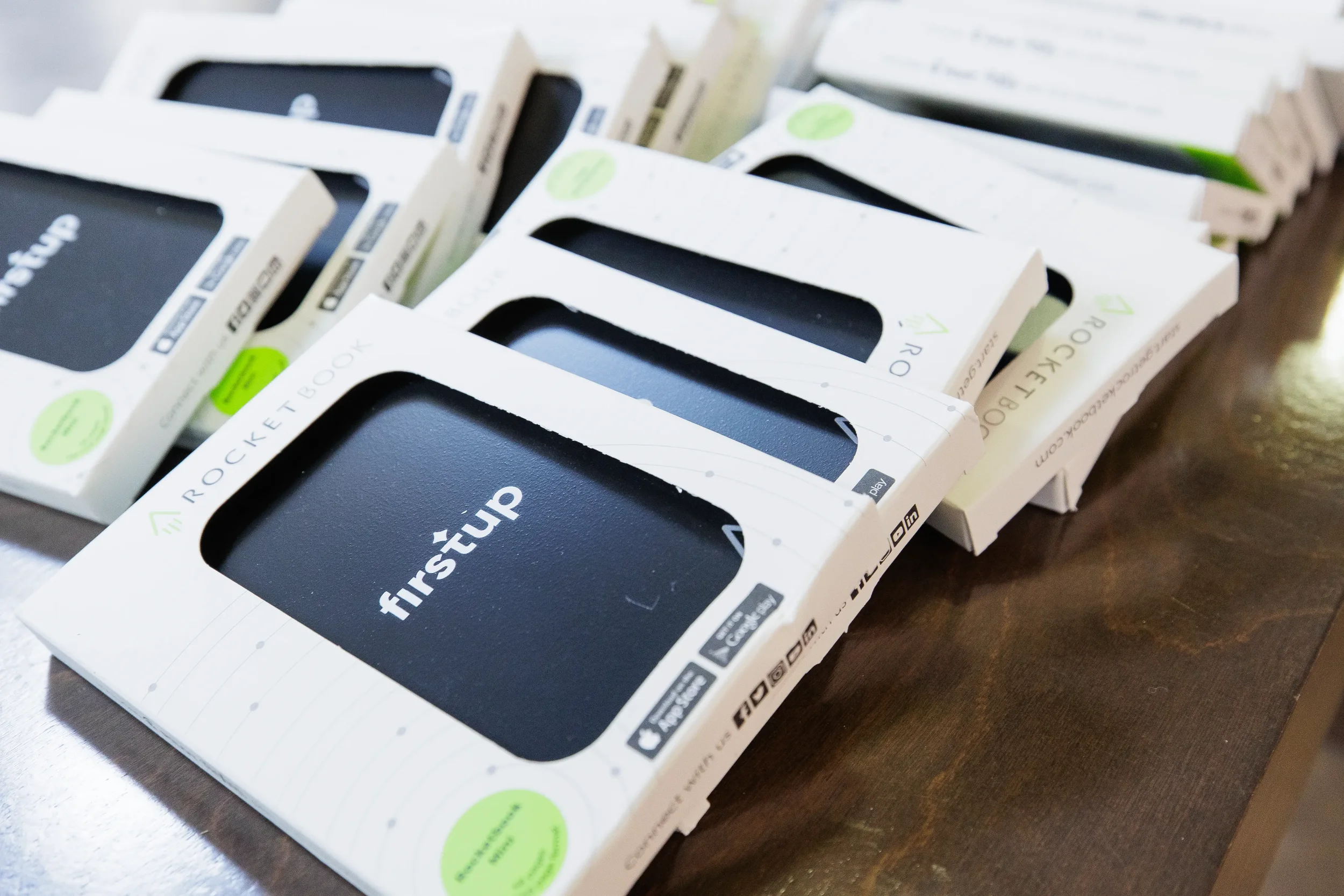 Branded Rocketbook notebooks arranged as conference swag on a table at Chicago corporate event