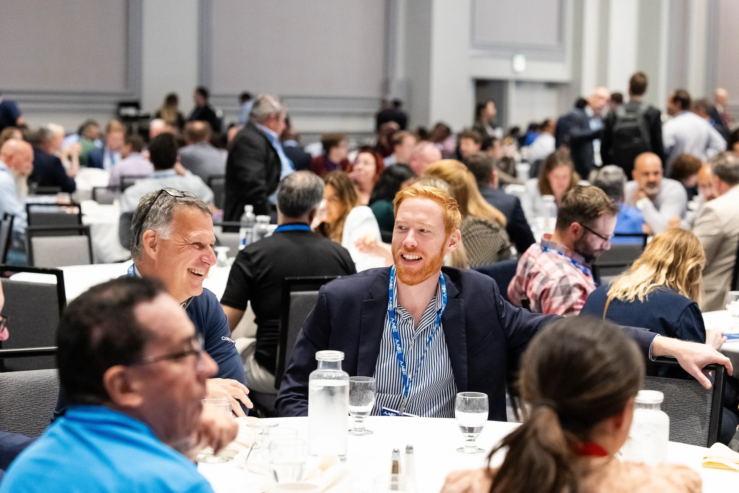 Two attendees share a laugh at round table during Orlando corporate conference event