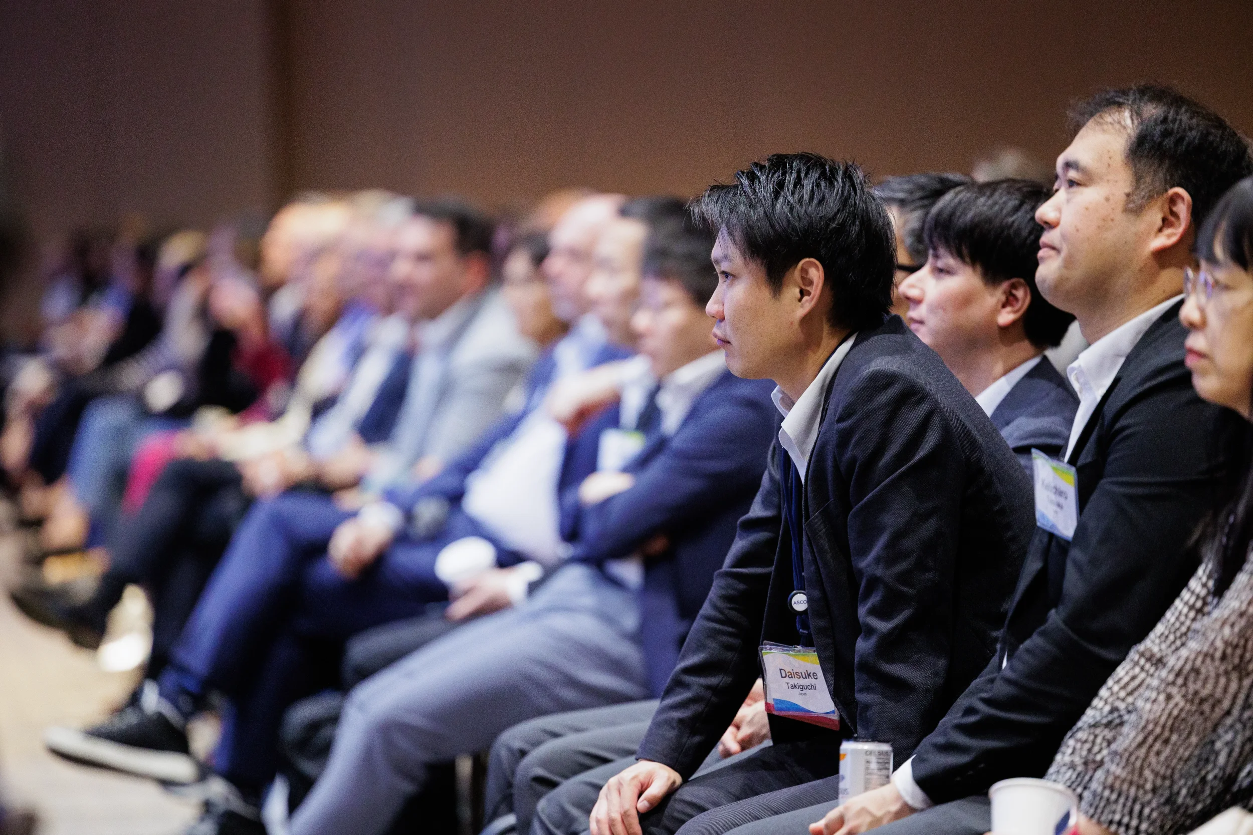 Audience members listen attentively during seated session at Orlando industry conference