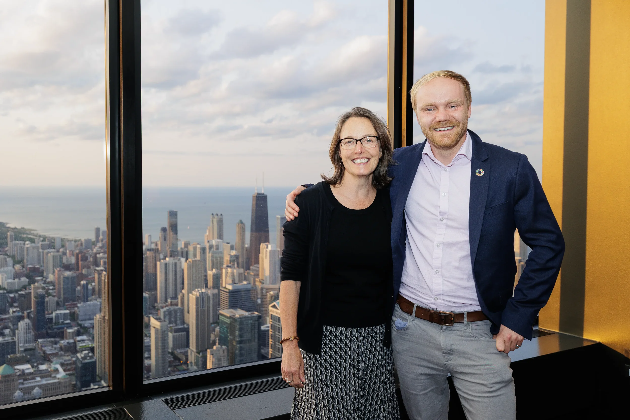 Two attendees smile for portrait with skyline view at Orlando corporate conference venue