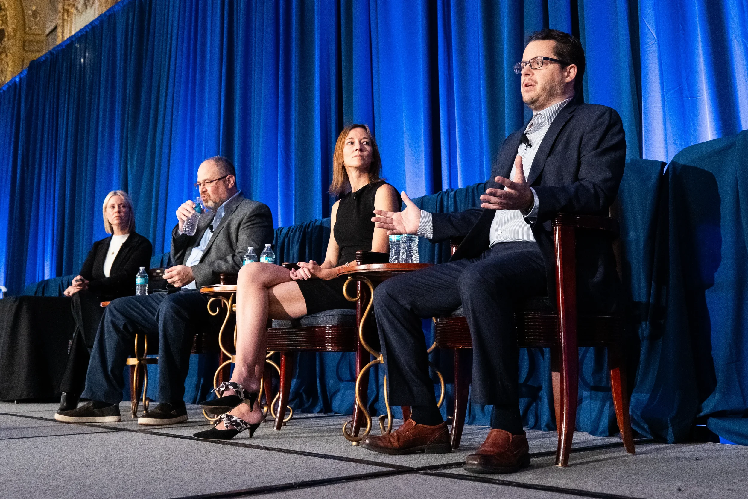 Panelist speaks during industry discussion on stage at AACE International 2024 in Orlando