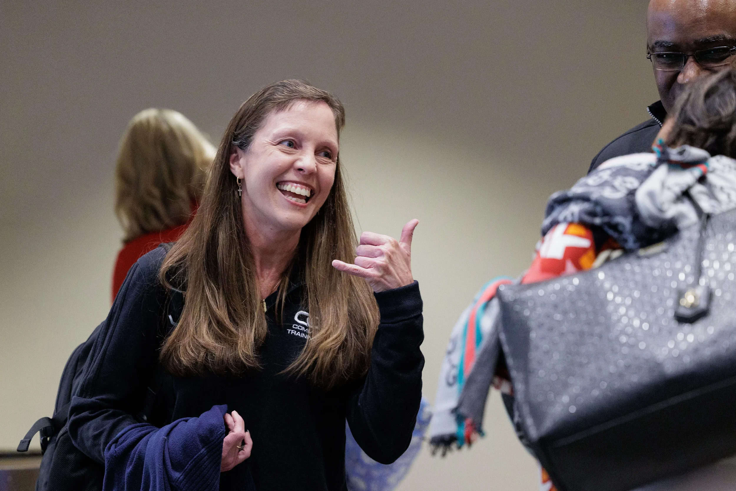 Smiling female attendee gestures enthusiastically while networking at Chicago corporate conference