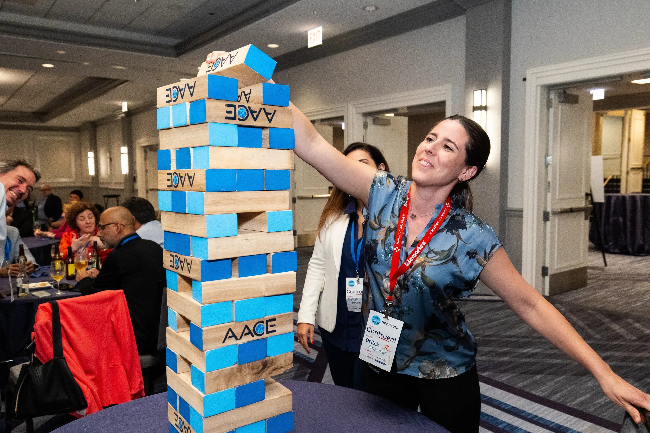 Conference attendee plays giant Jenga during networking reception at Chicago corporate event
