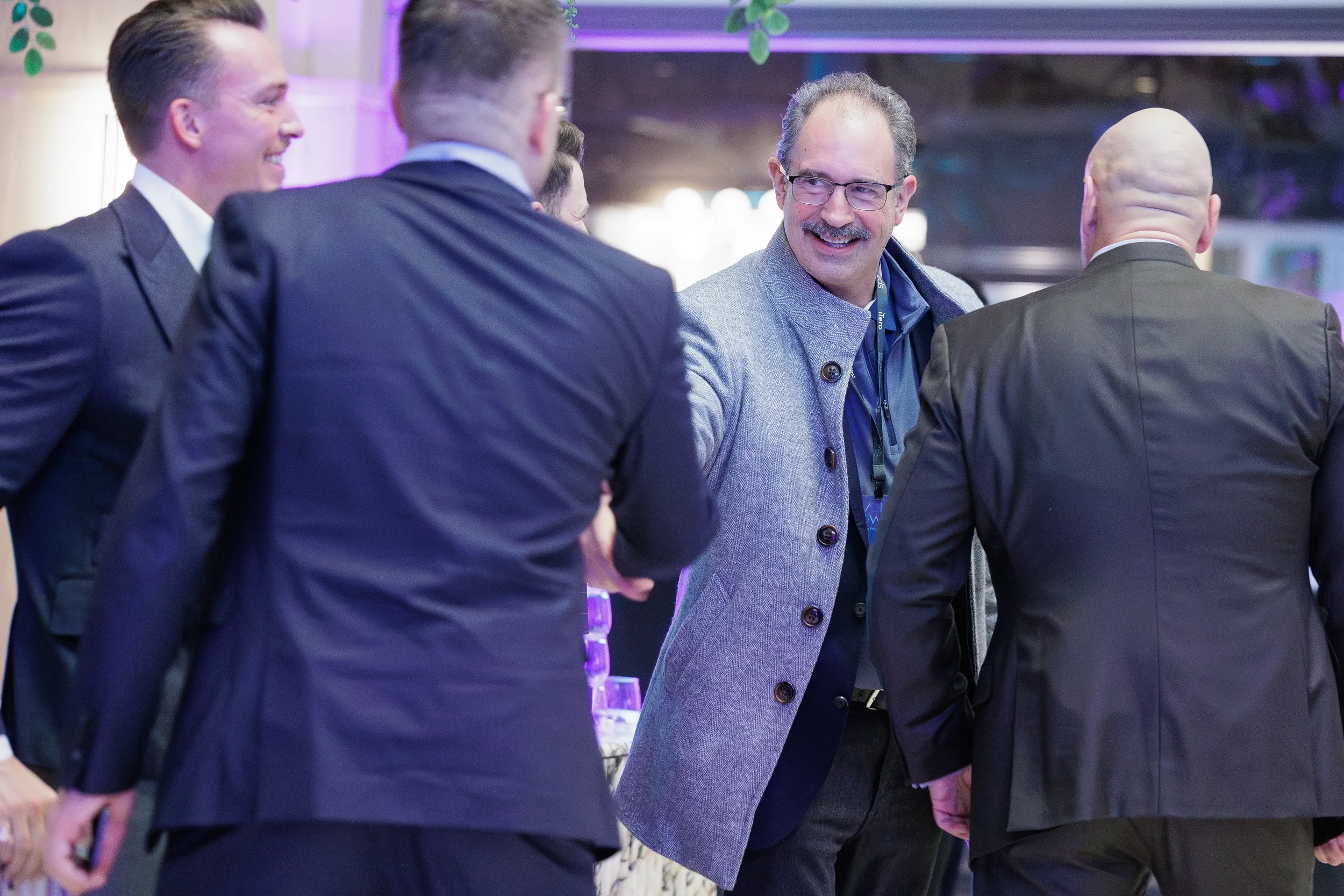 Attendees smile and shake hands while networking at Chicago corporate event reception