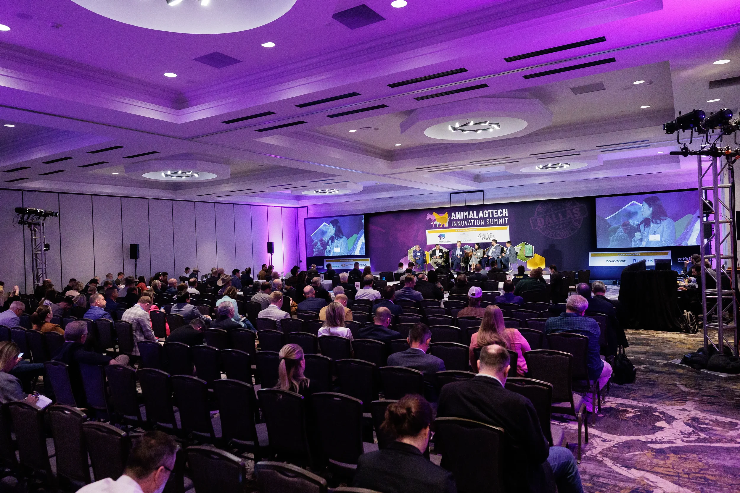 Wide view of ballroom audience watching panel discussion on stage at Chicago corporate summit
