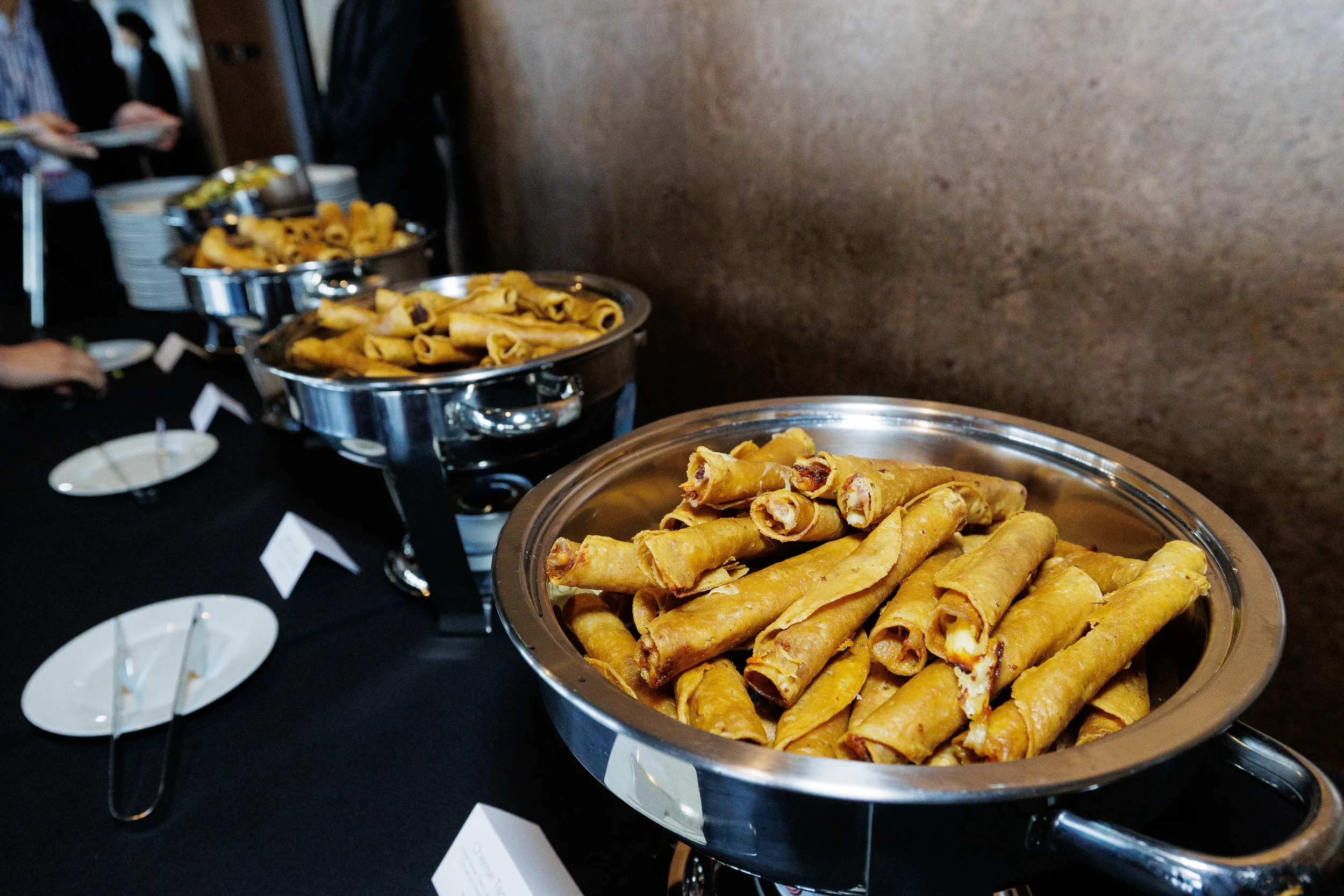 Taquito appetizers displayed on catering table at Chicago corporate event