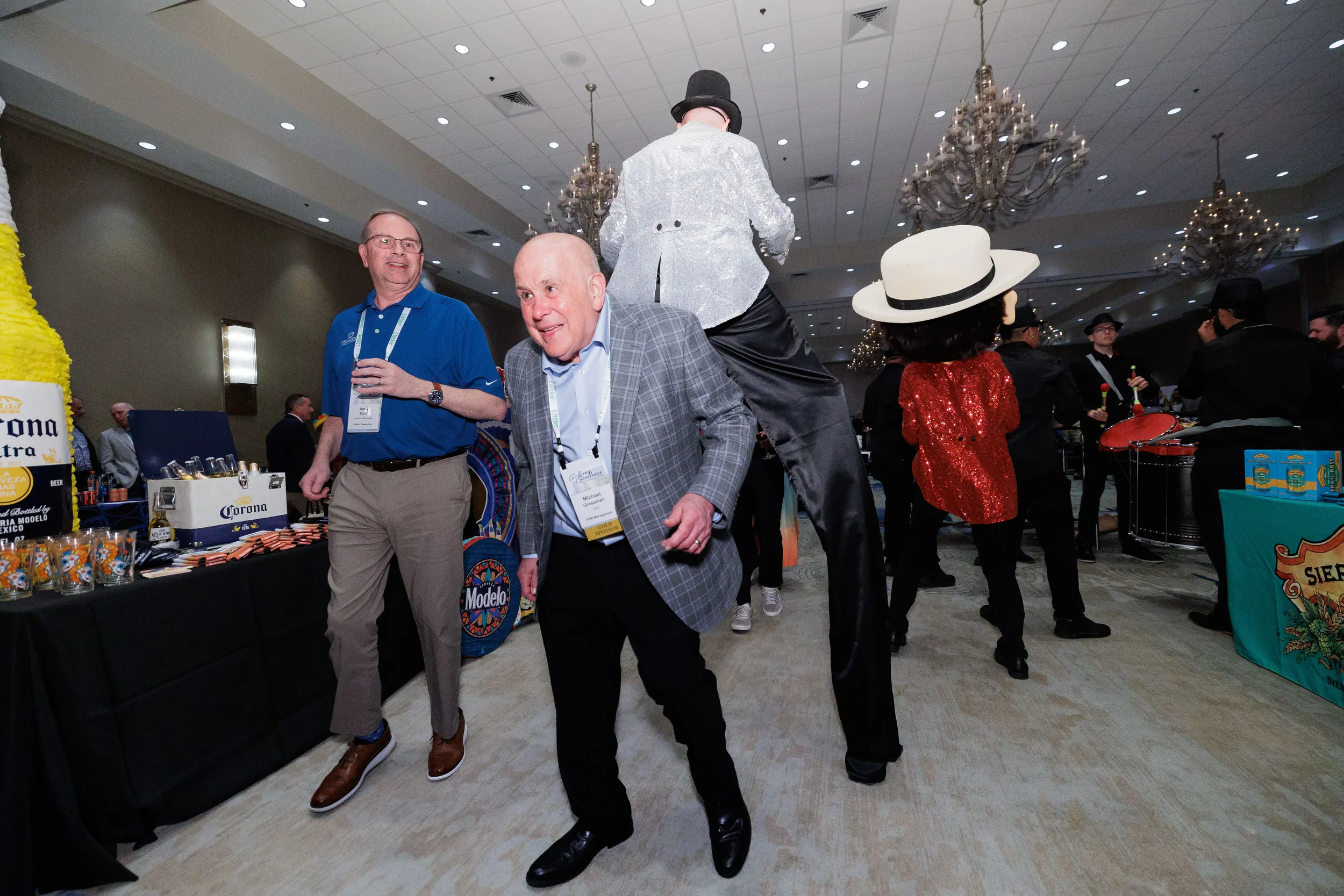 Attendees mingle near live performers in sequin costumes at Chicago corporate conference evening reception